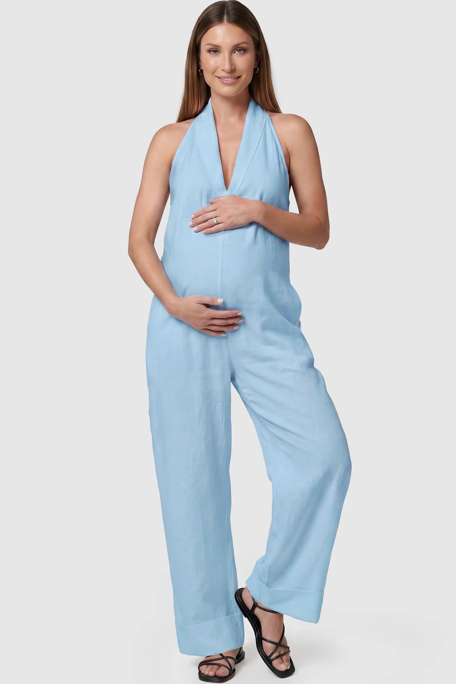 Halter Neck Wide-Leg Maternity Jumpsuit Halter neck wide-leg maternity jumpsuit in blue with chic halter neckline, front view on pregnant model