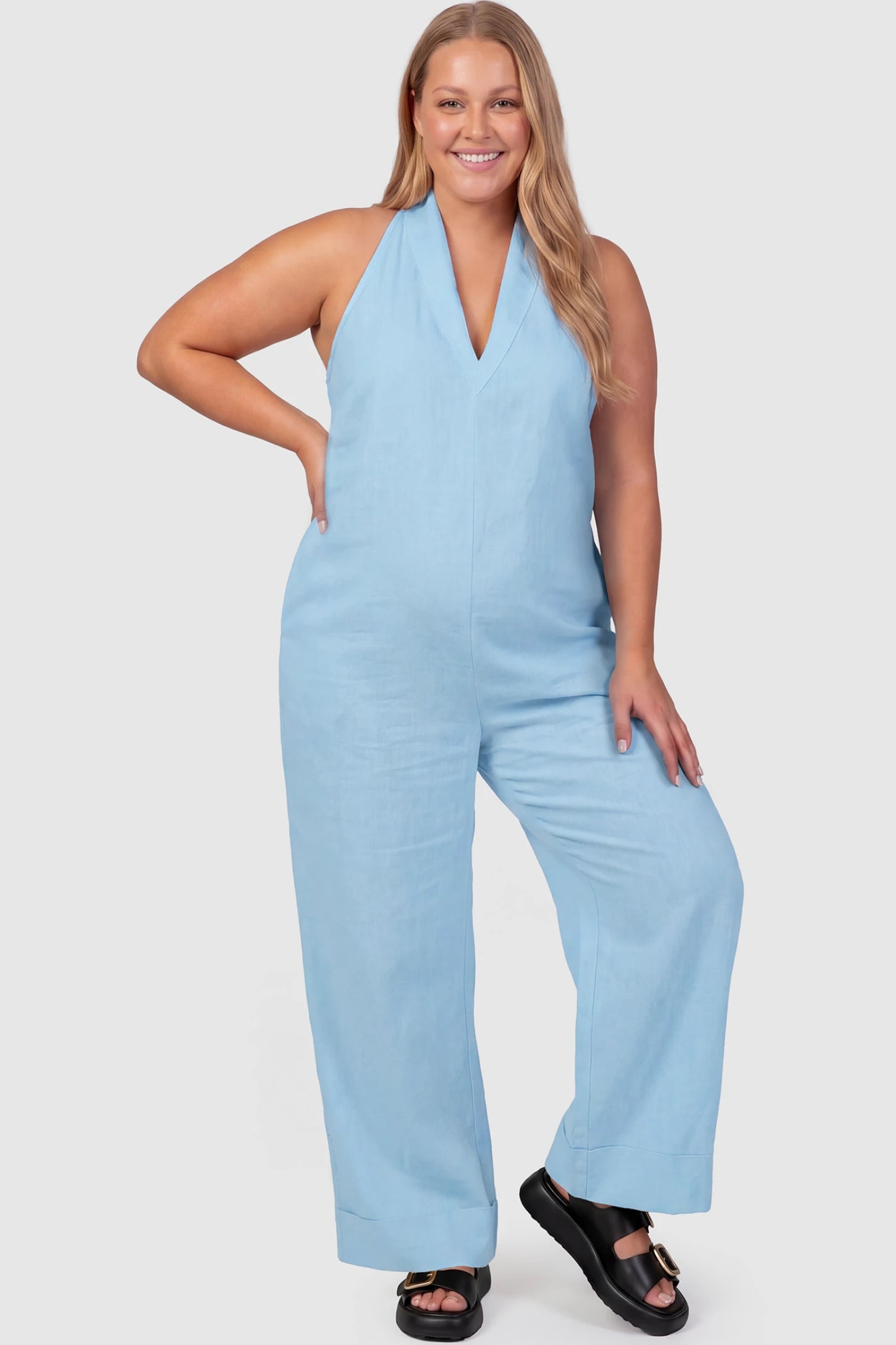 Halter Neck Wide-Leg Maternity Jumpsuit Halter neck wide-leg maternity jumpsuit in blue with chic halter neckline, front view on plus-size model