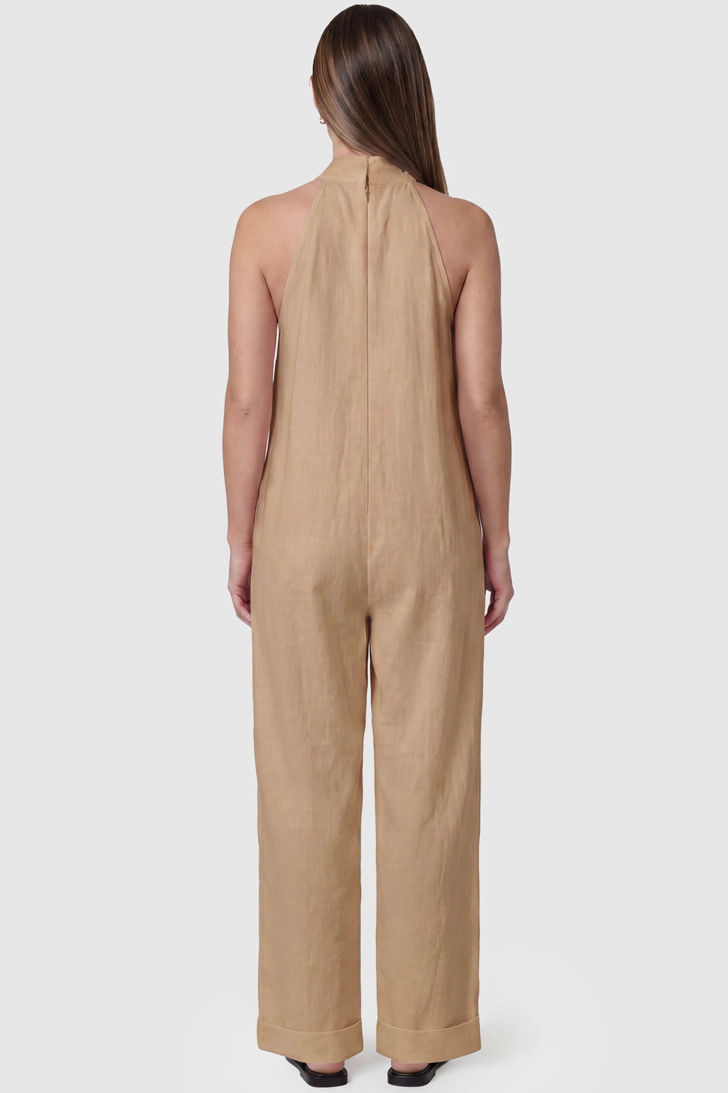 Halter Neck Wide-Leg Maternity Jumpsuit Halter neck wide-leg maternity jumpsuit in camel with breathable cotton fabric, back view on pregnant model