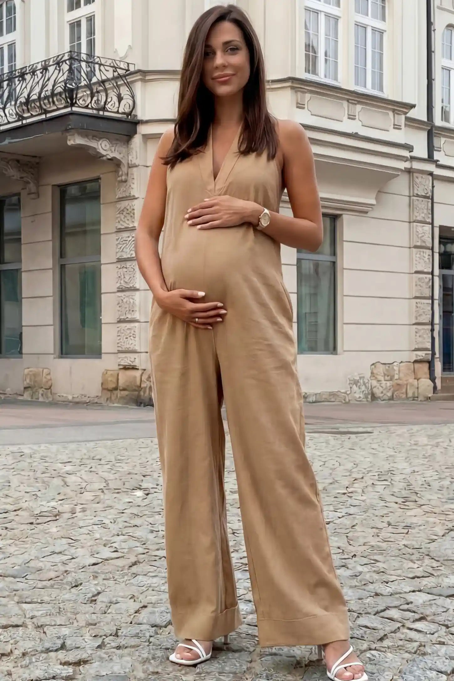 Halter Neck Wide-Leg Maternity Jumpsuit Halter neck wide-leg maternity jumpsuit in camel with chic halter neckline, front view on pregnant model