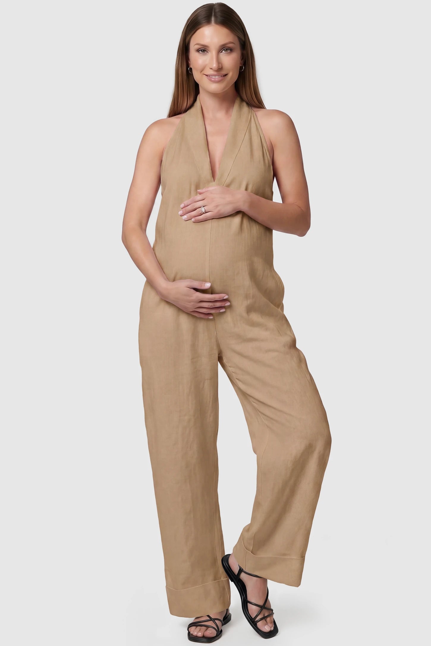 Halter Neck Wide-Leg Maternity Jumpsuit Halter neck wide-leg maternity jumpsuit in camel with chic halter neckline, front view on pregnant model