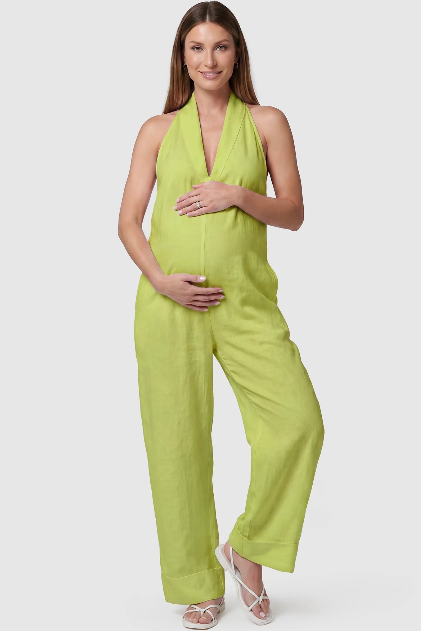 Halter Neck Wide-Leg Maternity Jumpsuit Halter neck wide-leg maternity jumpsuit in green with chic halter neckline, front view on pregnant model