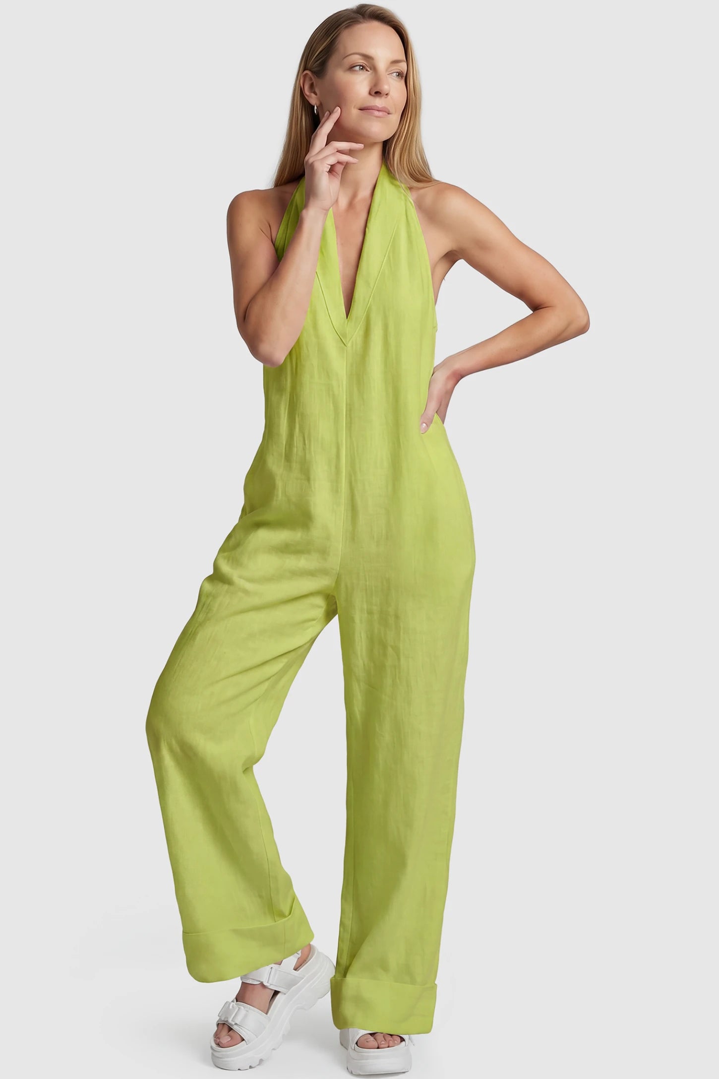 Halter Neck Wide-Leg Maternity Jumpsuit Halter neck wide-leg maternity jumpsuit in green with chic halter neckline, front view on postpartum model
