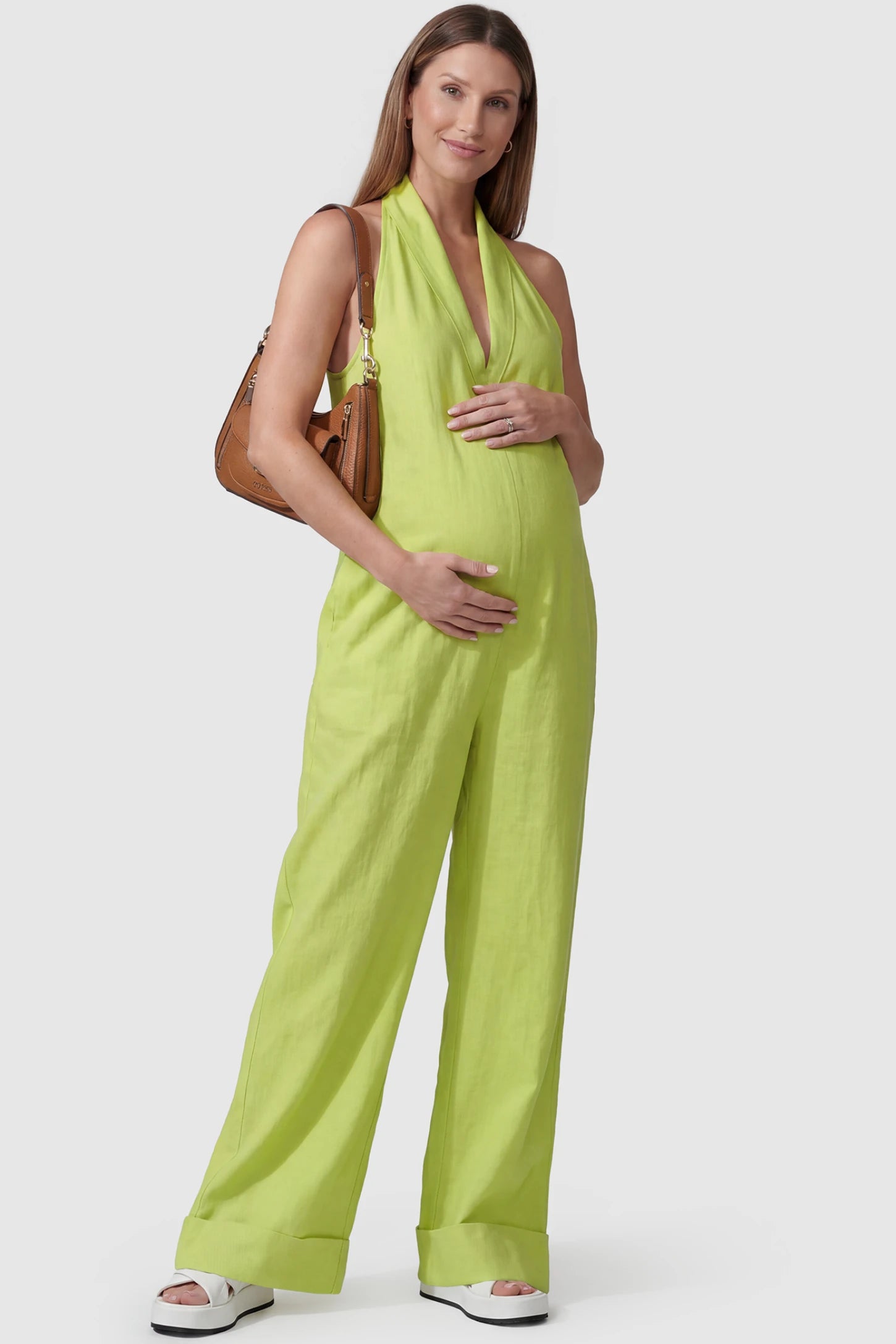 Halter Neck Wide-Leg Maternity Jumpsuit Halter neck wide-leg maternity jumpsuit in green with chic halter neckline, front view on pregnant model