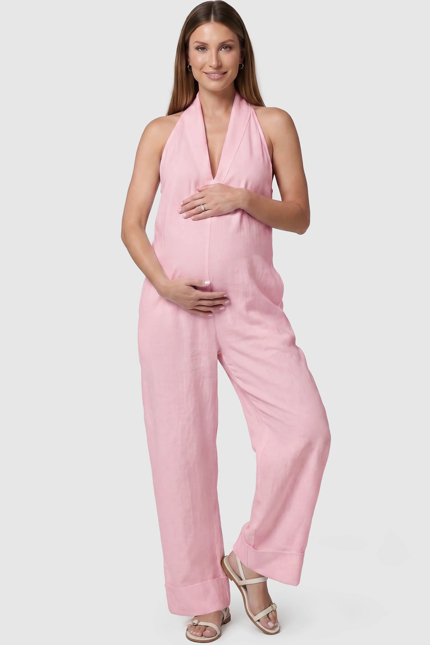 Halter Neck Wide-Leg Maternity Jumpsuit Halter neck wide-leg maternity jumpsuit in pink with chic halter neckline, front view on pregnant model