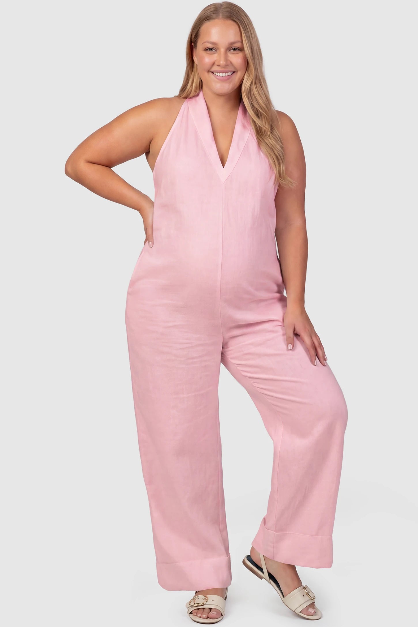 Halter Neck Wide-Leg Maternity Jumpsuit Halter neck wide-leg maternity jumpsuit in pink with chic halter neckline, front view on plus-size model