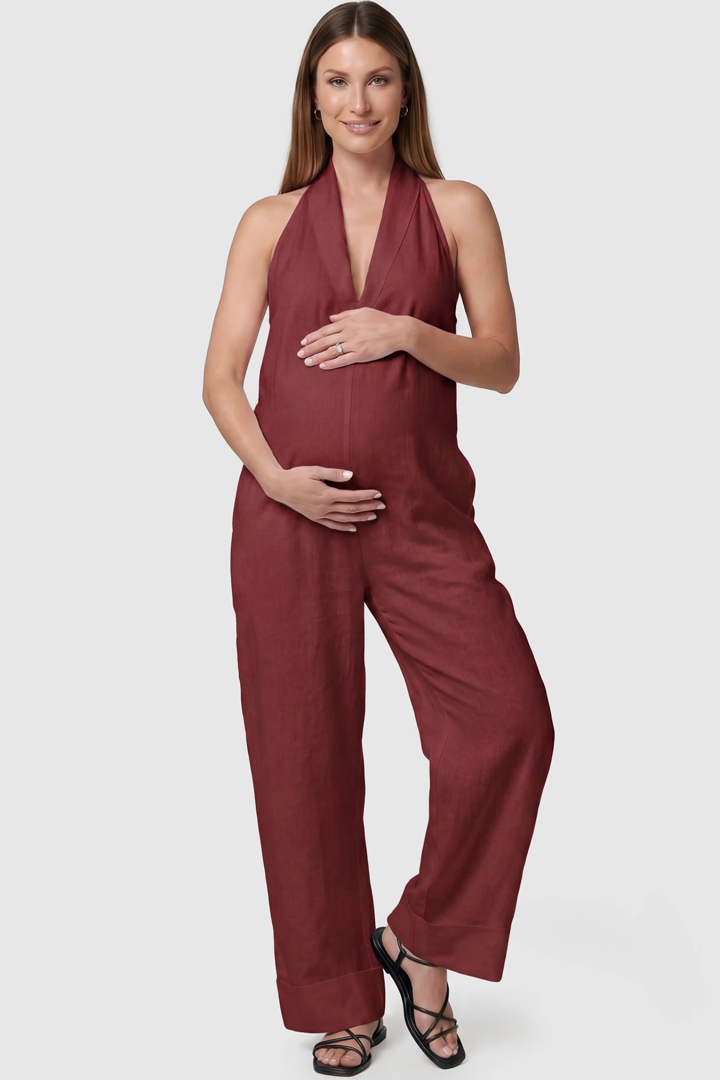 Halter Neck Wide-Leg Maternity Jumpsuit Halter neck wide-leg maternity jumpsuit in wine red with chic halter neckline, front view on pregnant model