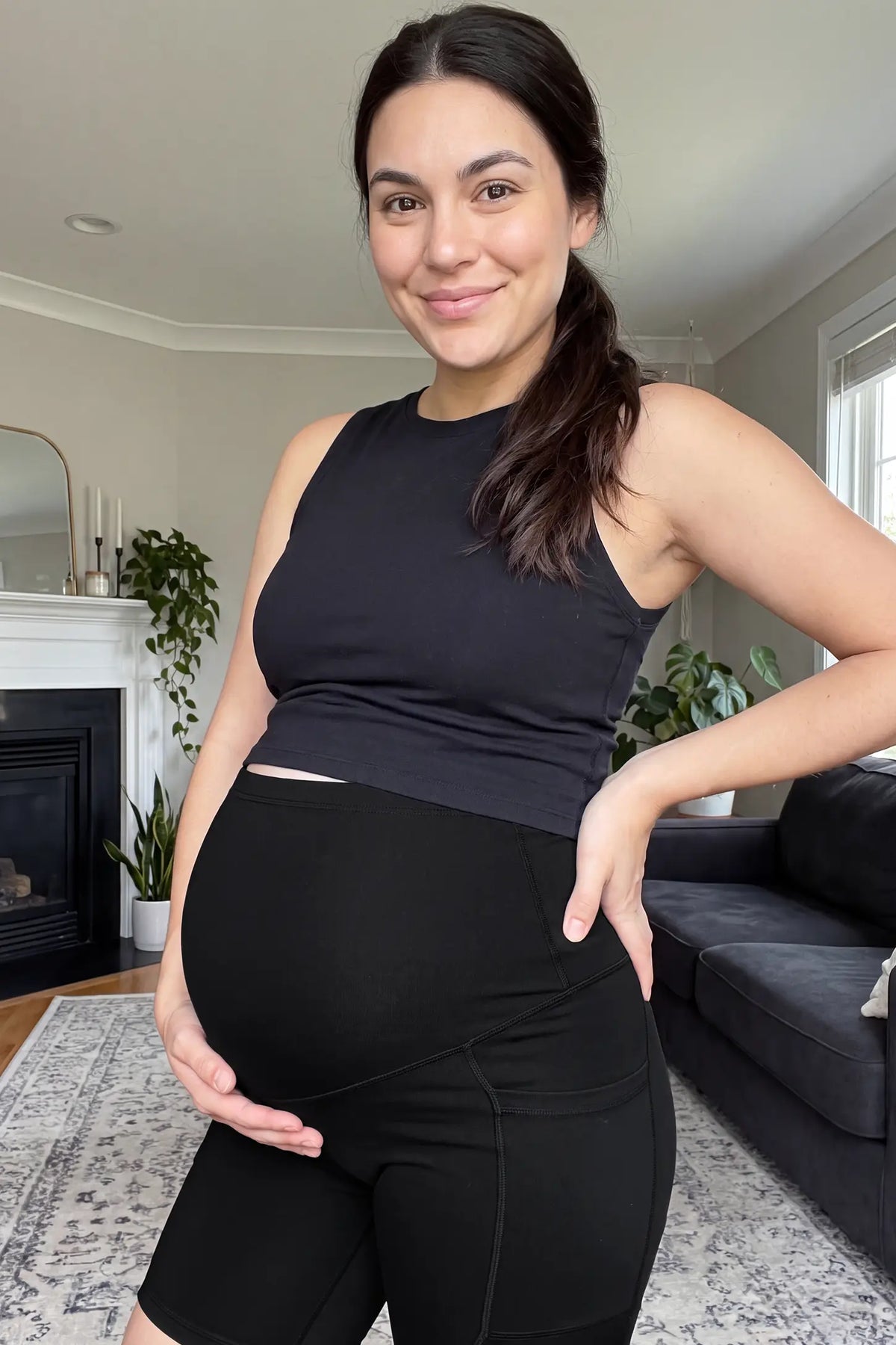 High-Rise Stretch Biker Maternity Shorts High-rise stretch biker maternity shorts in black featuring seamless fit, mid-thigh length, and supportive belly panel on pregnant model. front view