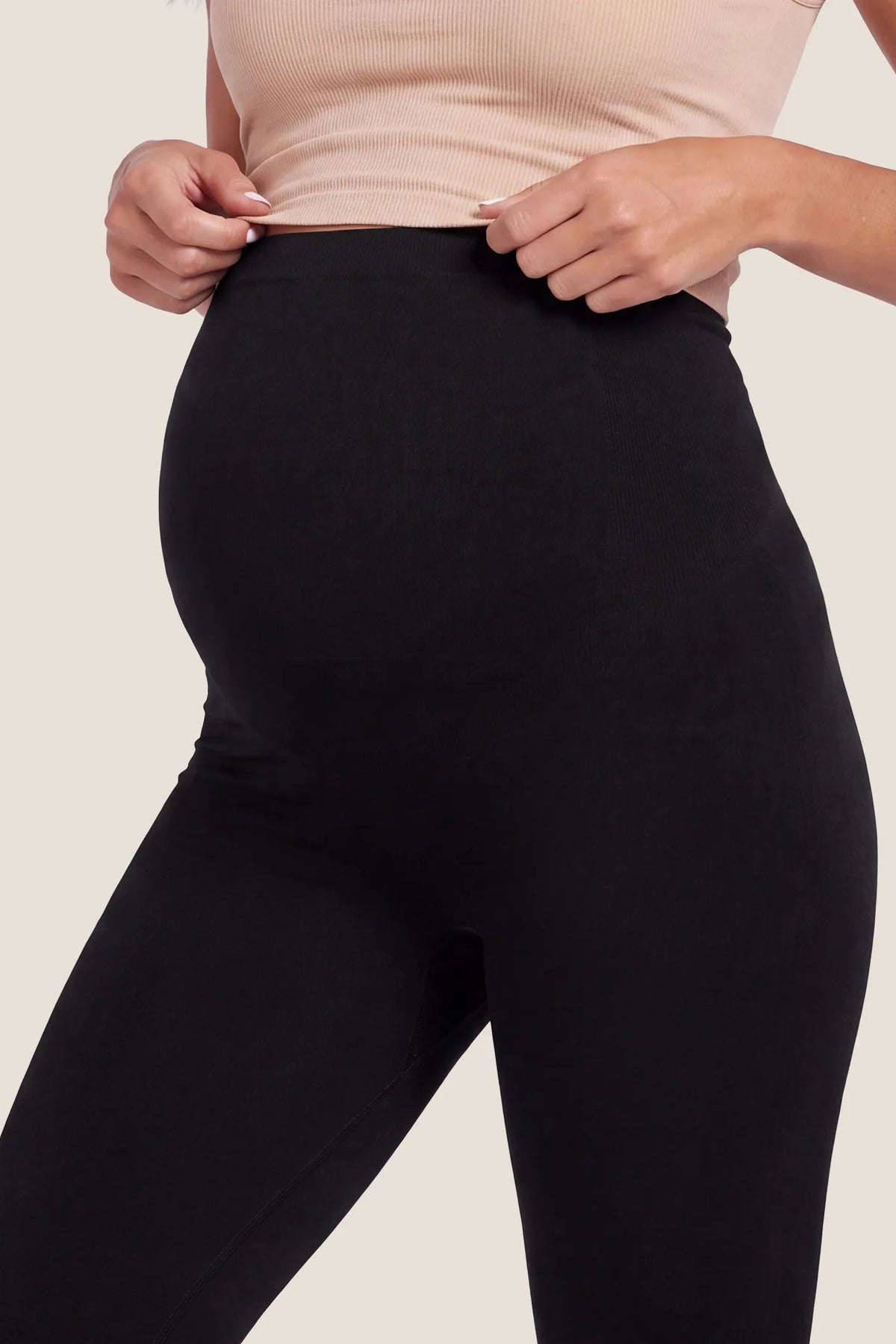 High Waist Full Length Maternity Leggings High Waist Full Length Maternity Leggings in Black featuring high-waisted seamless knit waistband design, optimal belly support, and stretchy breathable fabric texture on a pregnant model.
