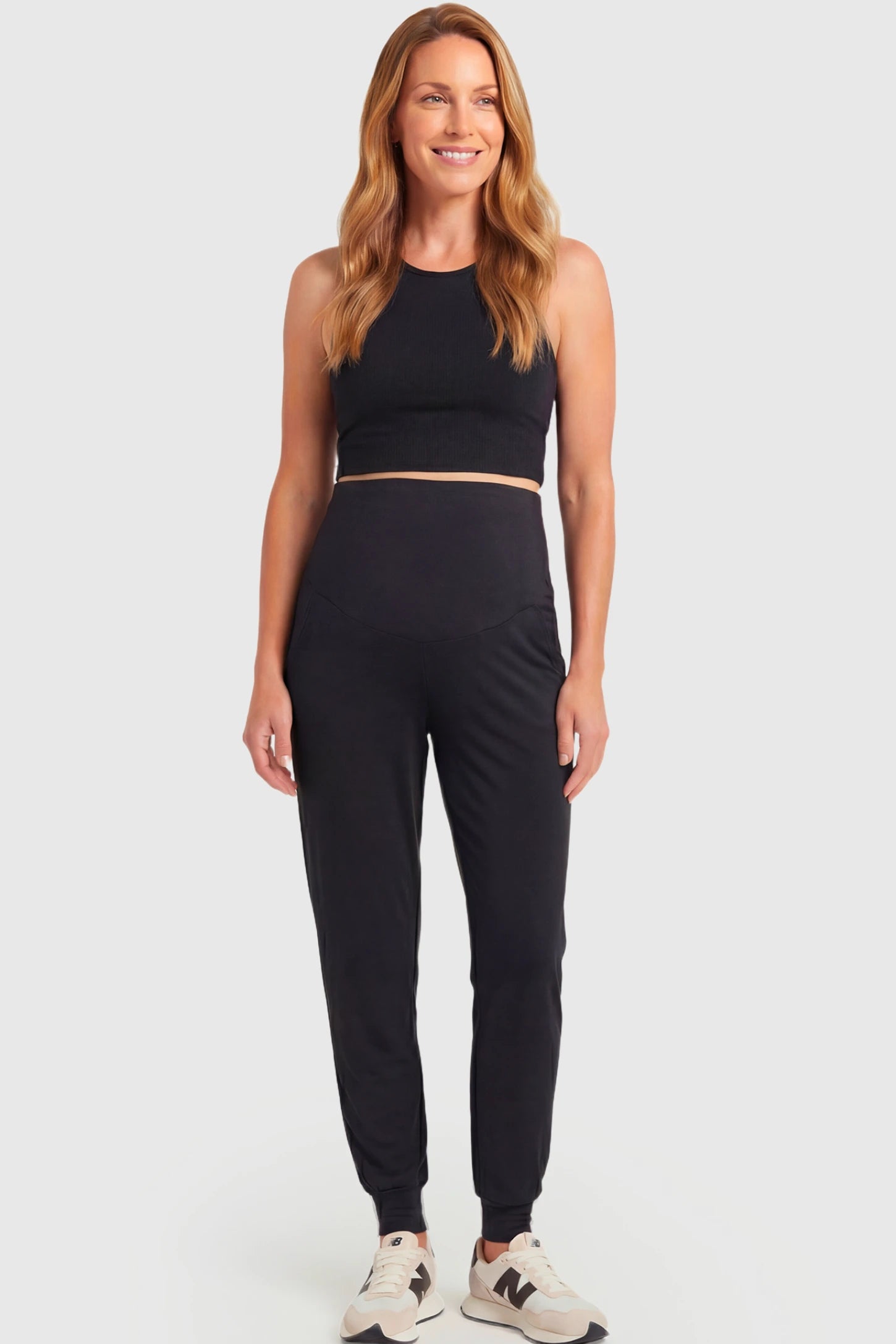 Full-Panel Cuffed Maternity Joggers Full-Panel Cuffed Maternity Joggers in black featuring high-rise over-the-belly panel, ribbed cuff hem, and side pockets on non pregnant model.