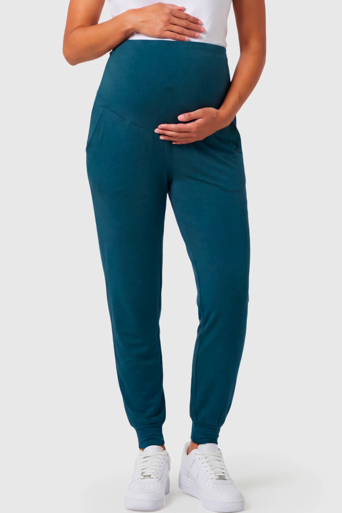 Full-Panel Cuffed Maternity Joggers Full-Panel Cuffed Maternity Joggers in blue featuring high-rise over-the-belly panel, ribbed cuff hem, and side pockets on pregnant model.