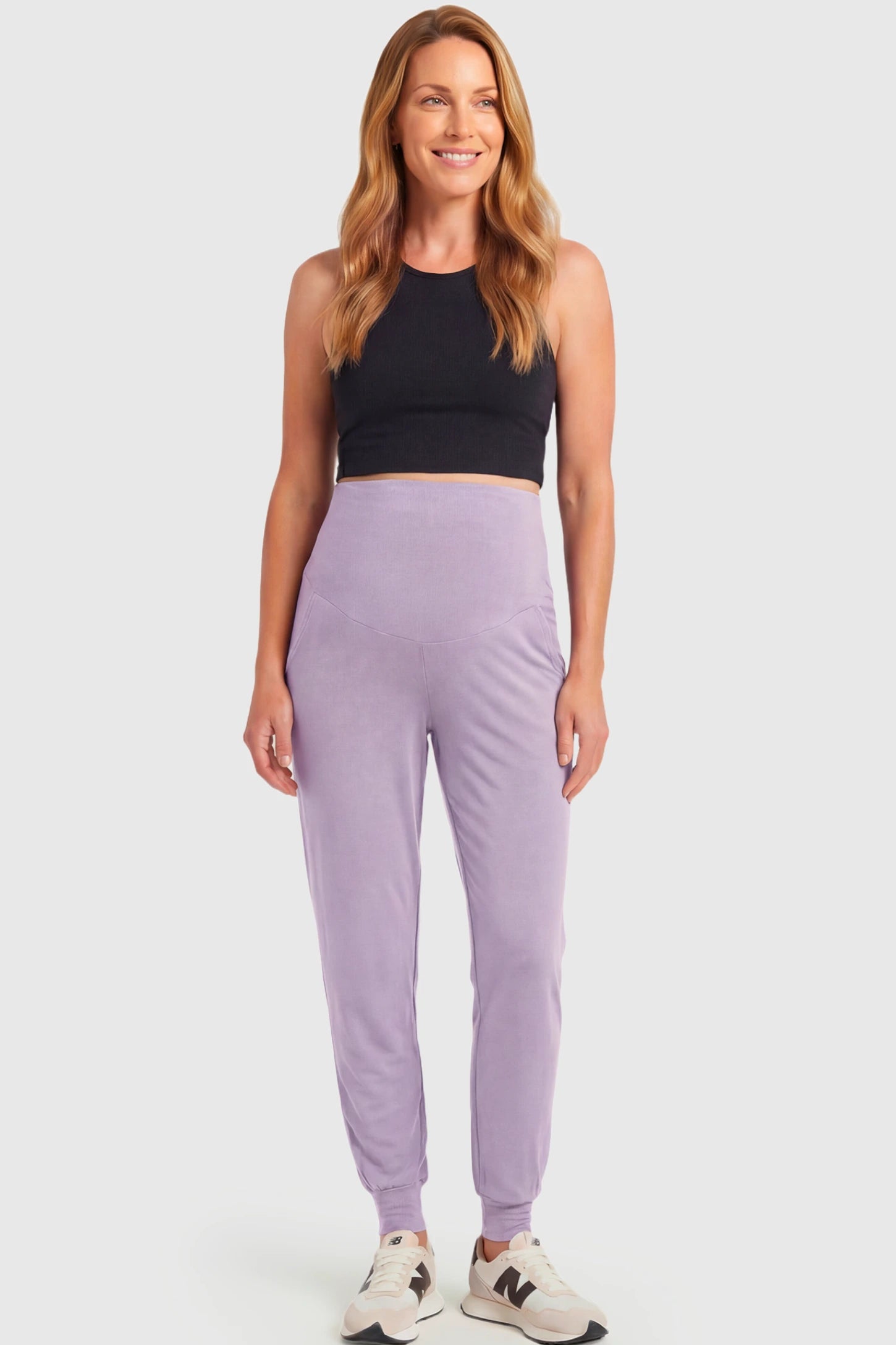 Full-Panel Cuffed Maternity Joggers Full-Panel Cuffed Maternity Joggers in lavender featuring high-rise over-the-belly panel, ribbed cuff hem, and side pockets on non pregnant model.