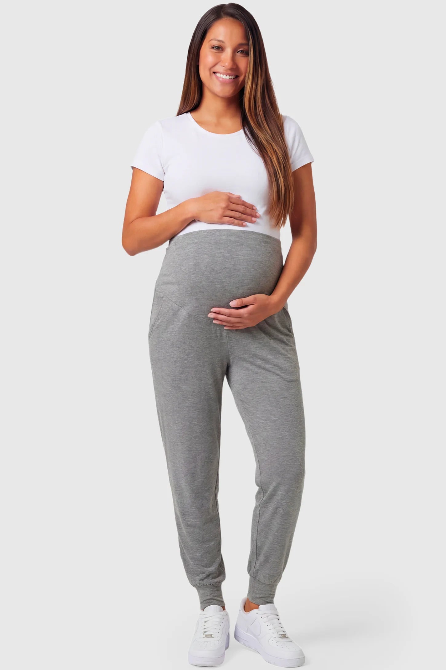 Full-Panel Cuffed Maternity Joggers Full-Panel Cuffed Maternity Joggers in light gray featuring high-rise over-the-belly panel, ribbed cuff hem, and side pockets on pregnant model.