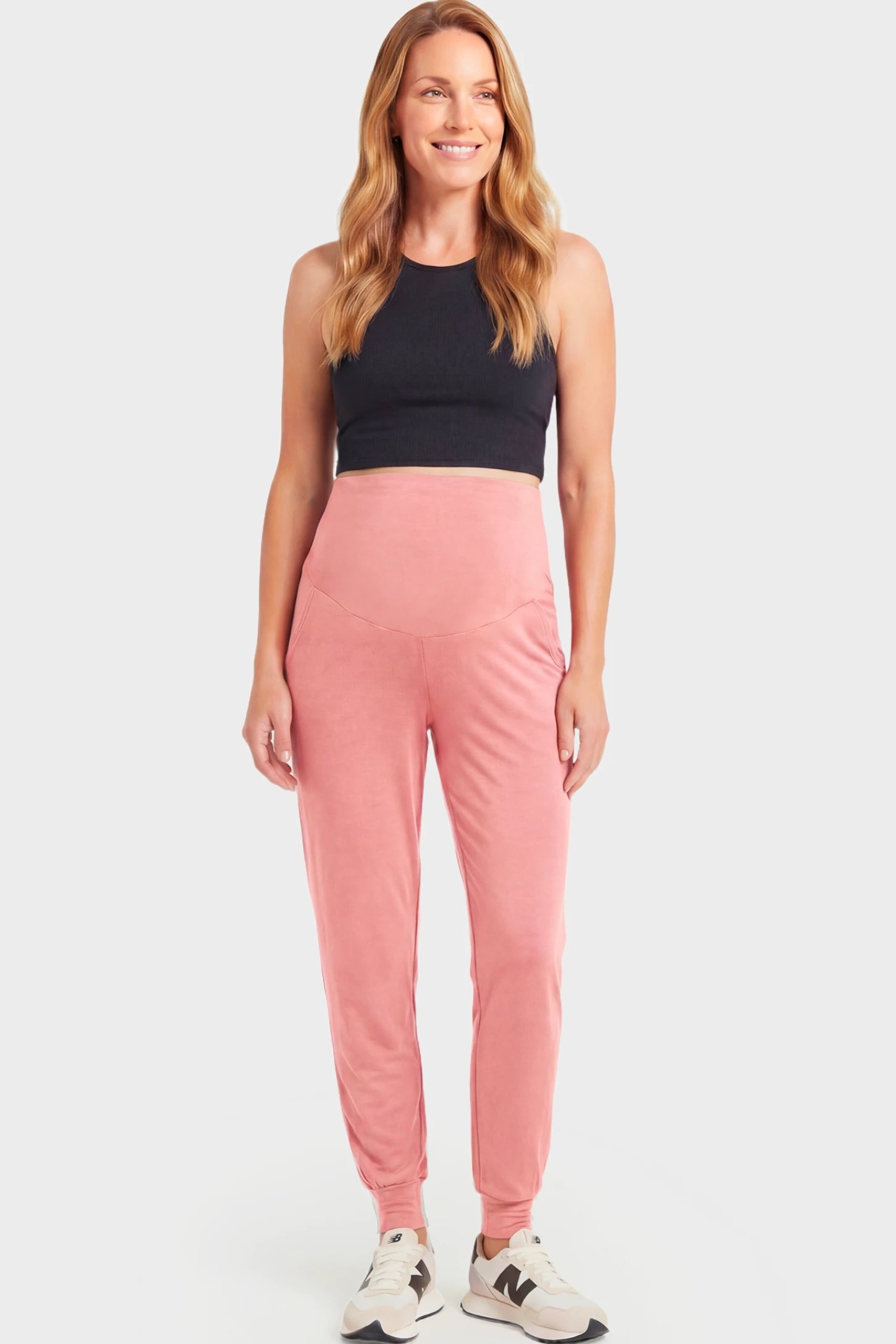 Full-Panel Cuffed Maternity Joggers Full-Panel Cuffed Maternity Joggers in pink featuring high-rise over-the-belly panel, ribbed cuff hem, and side pockets on non pregnant model.