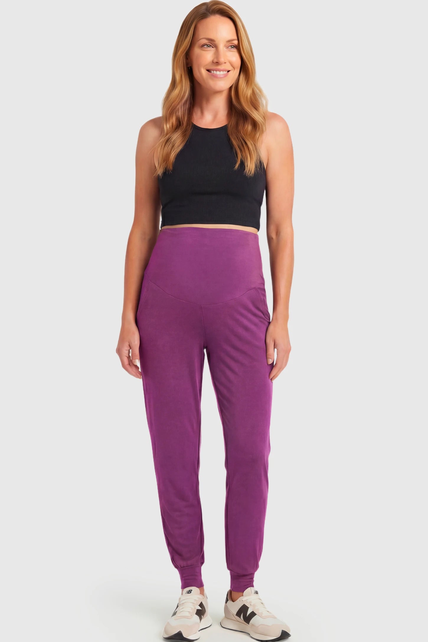 Full-Panel Cuffed Maternity Joggers Full-Panel Cuffed Maternity Joggers in purple featuring high-rise over-the-belly panel, ribbed cuff hem, and side pockets on non pregnant model.