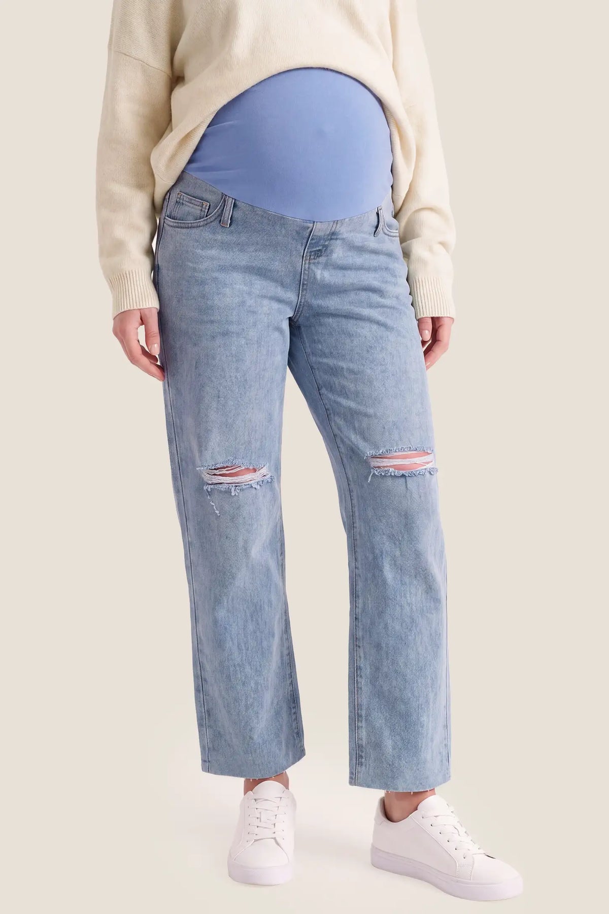 High-Waisted Distressed Maternity Jeans in Light Blue featuring full over-the-bump belly support, stretchy cotton-blend denim, and distressed knee details on a pregnant model, studio front view.