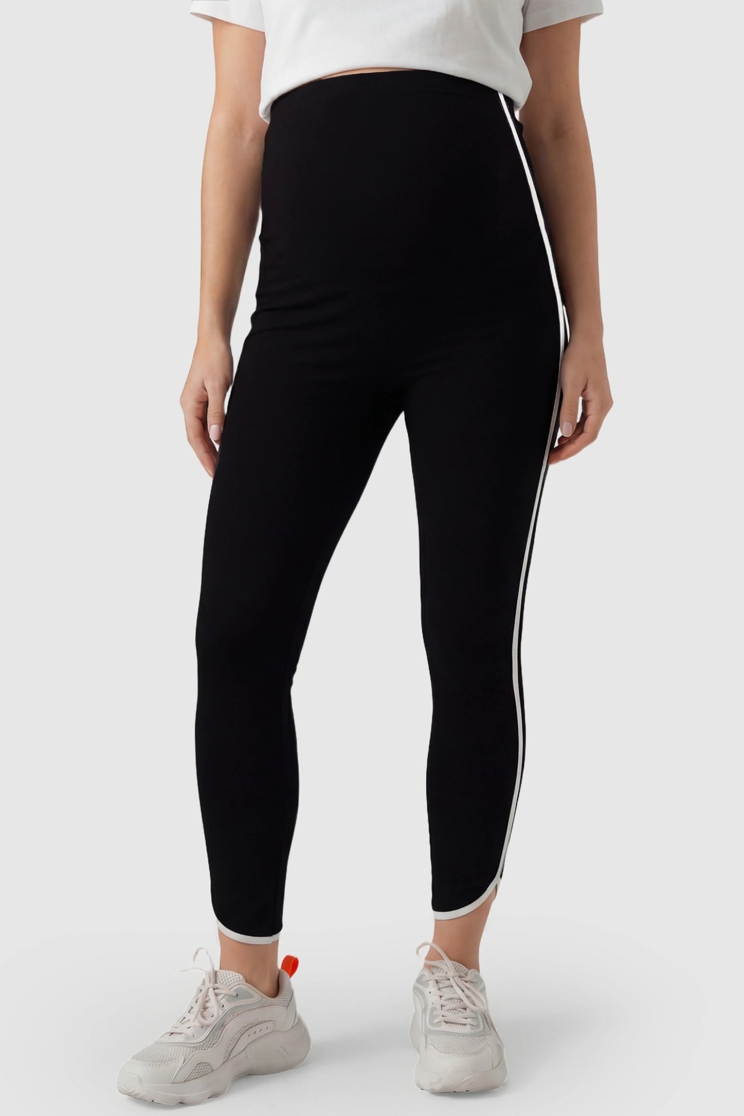 High Waisted Side Stripe Maternity Leggings in black featuring a supportive belly band on a pregnant model from the front.