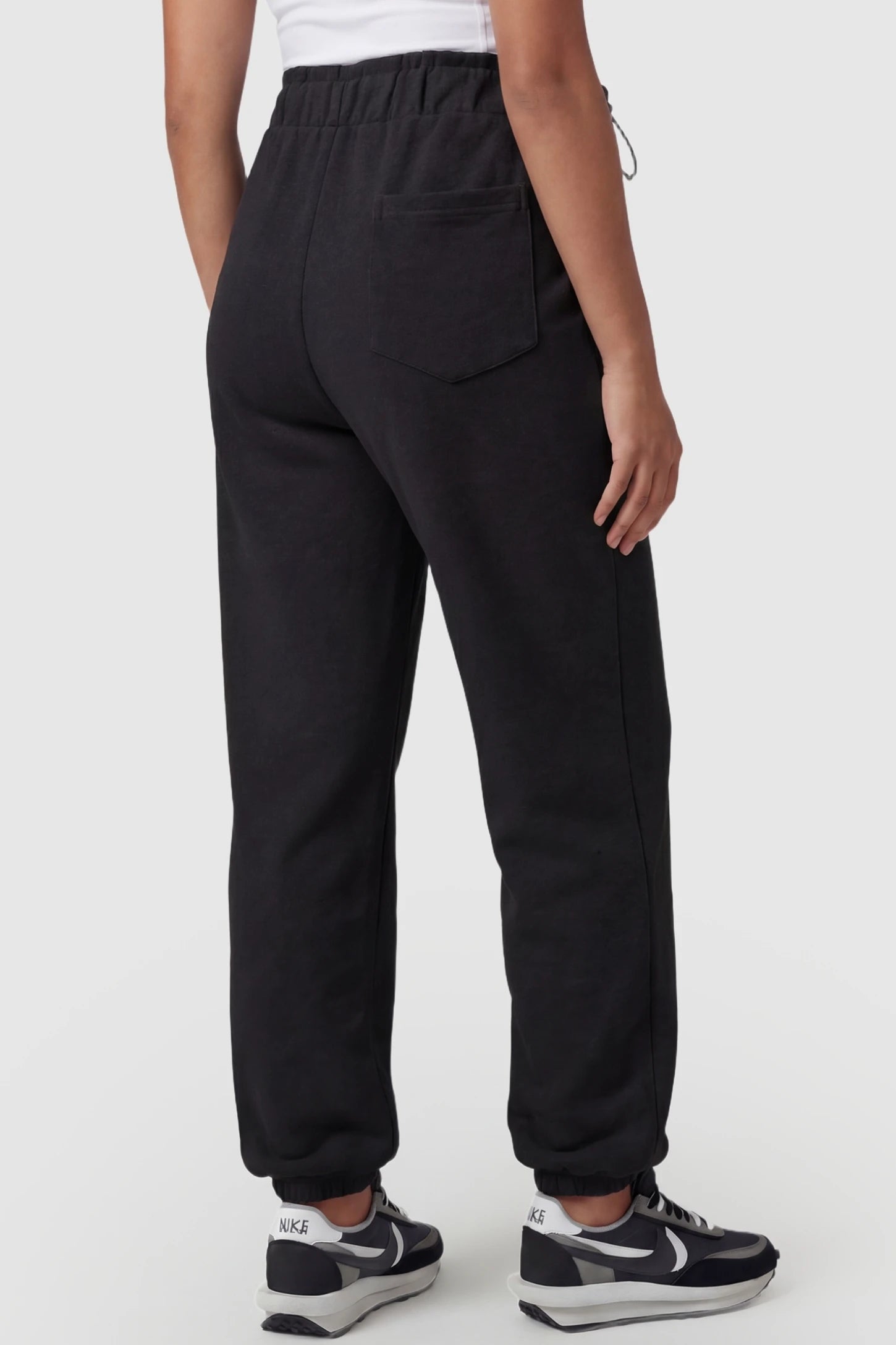 High-Rise Drawstring Waist Loose Fit Jogger Maternity Pants High-rise drawstring waist loose fit jogger maternity pants in black with tapered jogger cuffs, back view on pregnant model