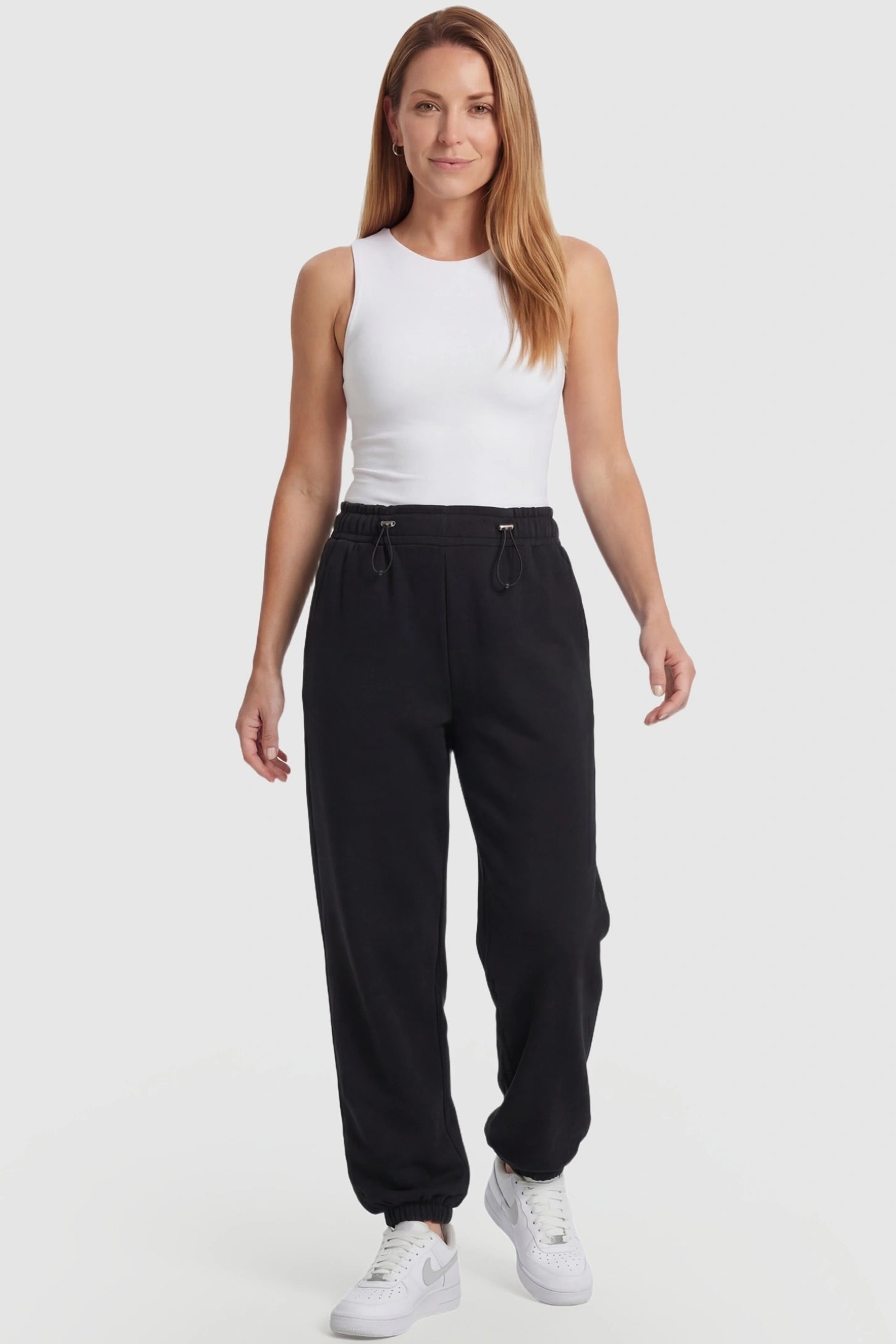 High-Rise Drawstring Waist Loose Fit Jogger Maternity Pants High-rise drawstring waist loose fit jogger maternity pants in black with relaxed fit & adjustable drawstring, full body on postpartum model