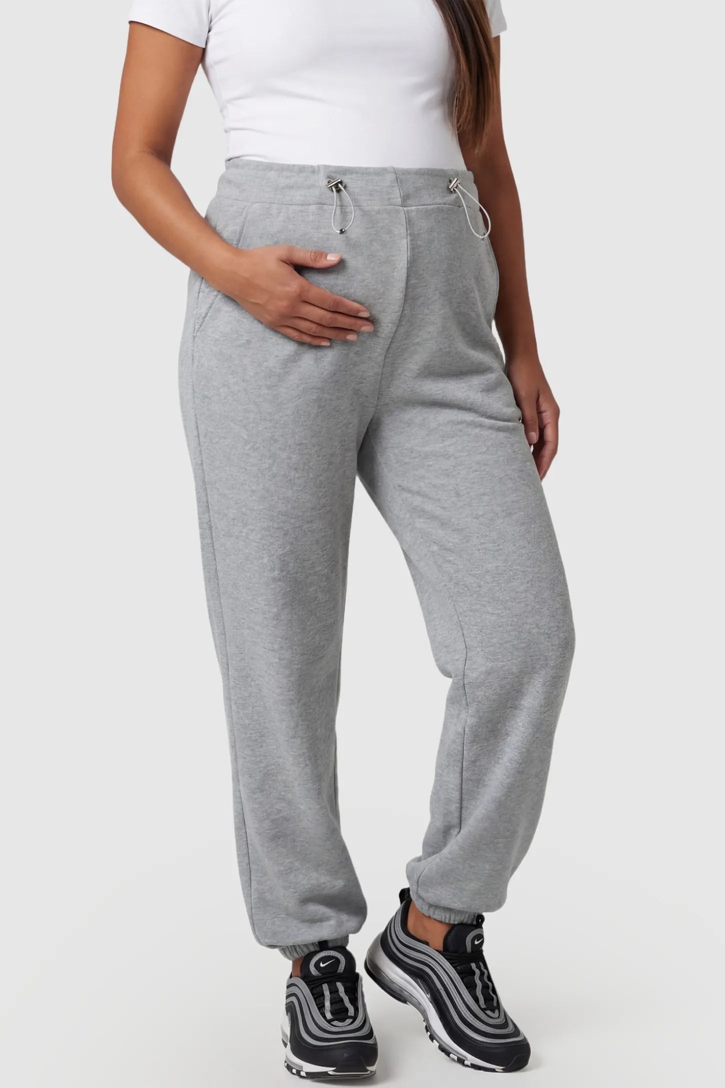 High-Rise Drawstring Waist Loose Fit Jogger Maternity Pants High-rise drawstring waist loose fit jogger maternity pants in gray with adjustable drawstring, front view on pregnant model