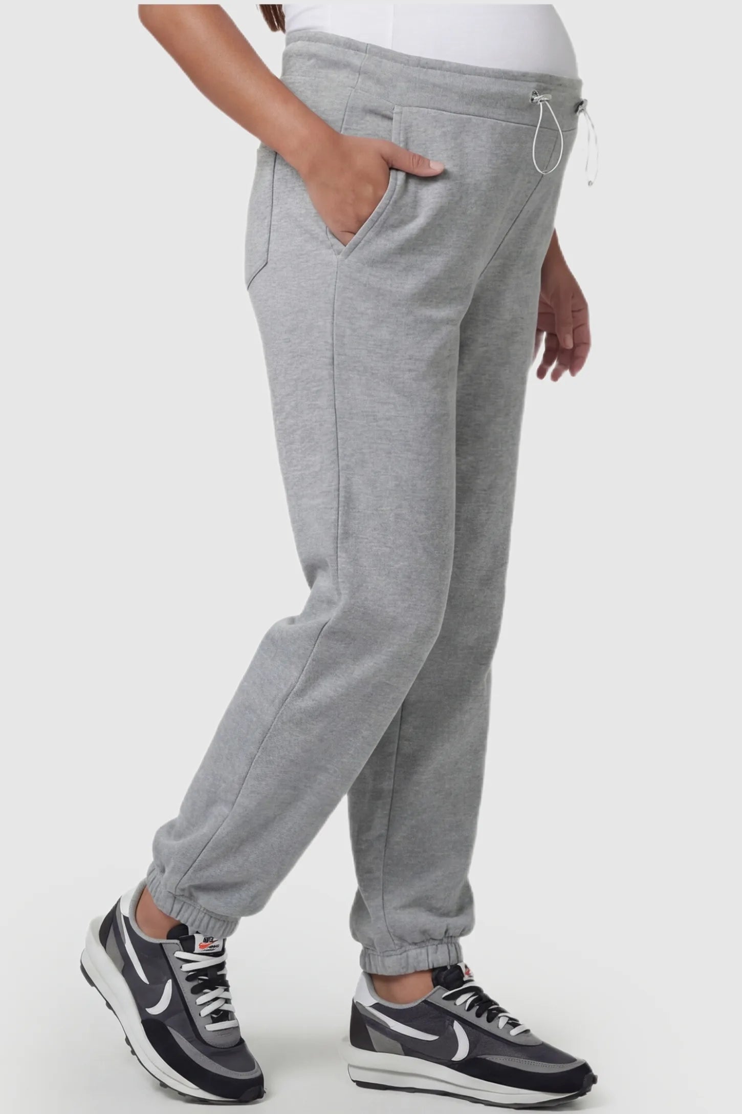 High-Rise Drawstring Waist Loose Fit Jogger Maternity Pants High-rise drawstring waist loose fit jogger maternity pants in gray with side pockets, side view on pregnant model