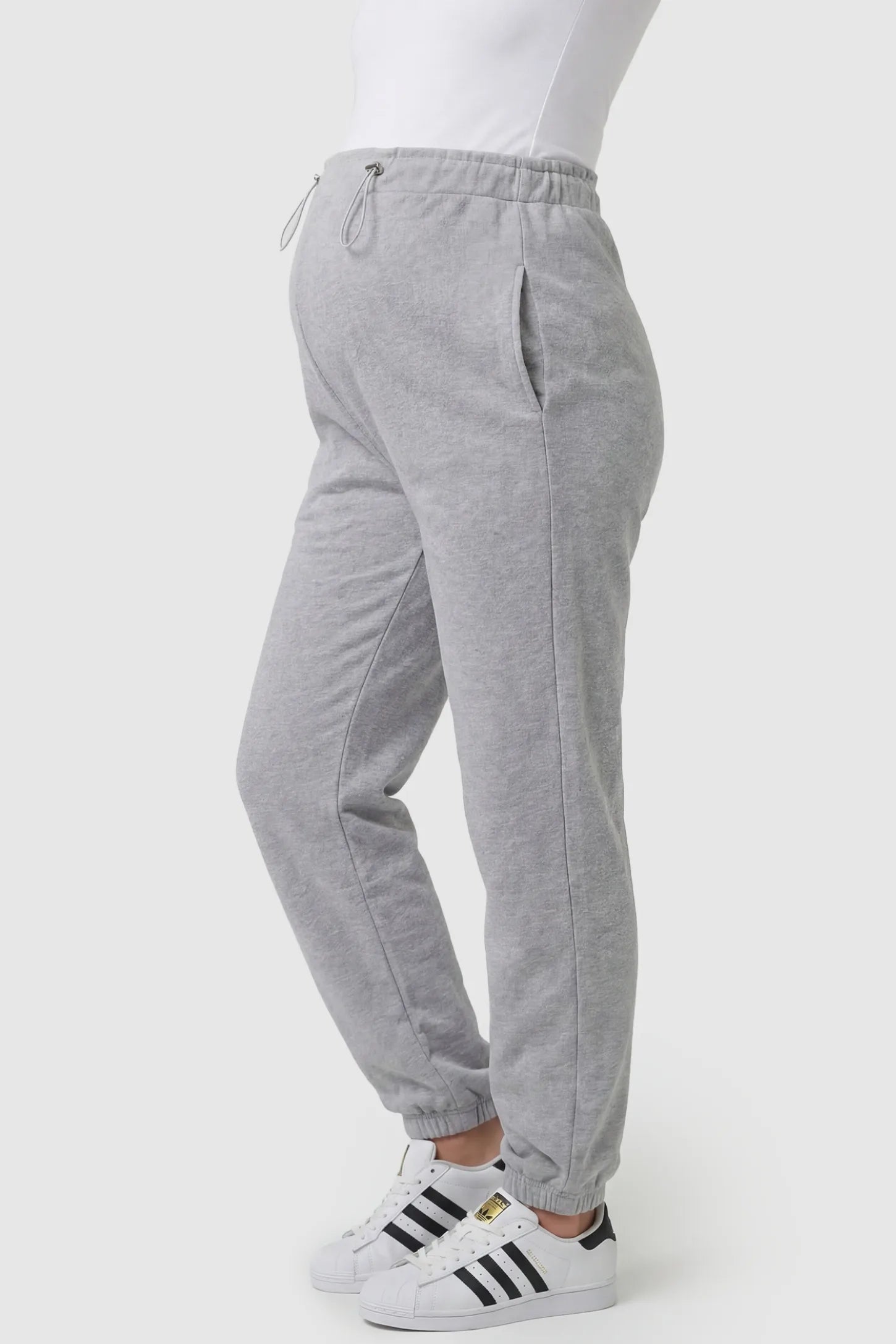 High-Rise Drawstring Waist Loose Fit Jogger Maternity Pants High-rise drawstring waist loose fit jogger maternity pants in gray with side pockets, side view on pregnant model