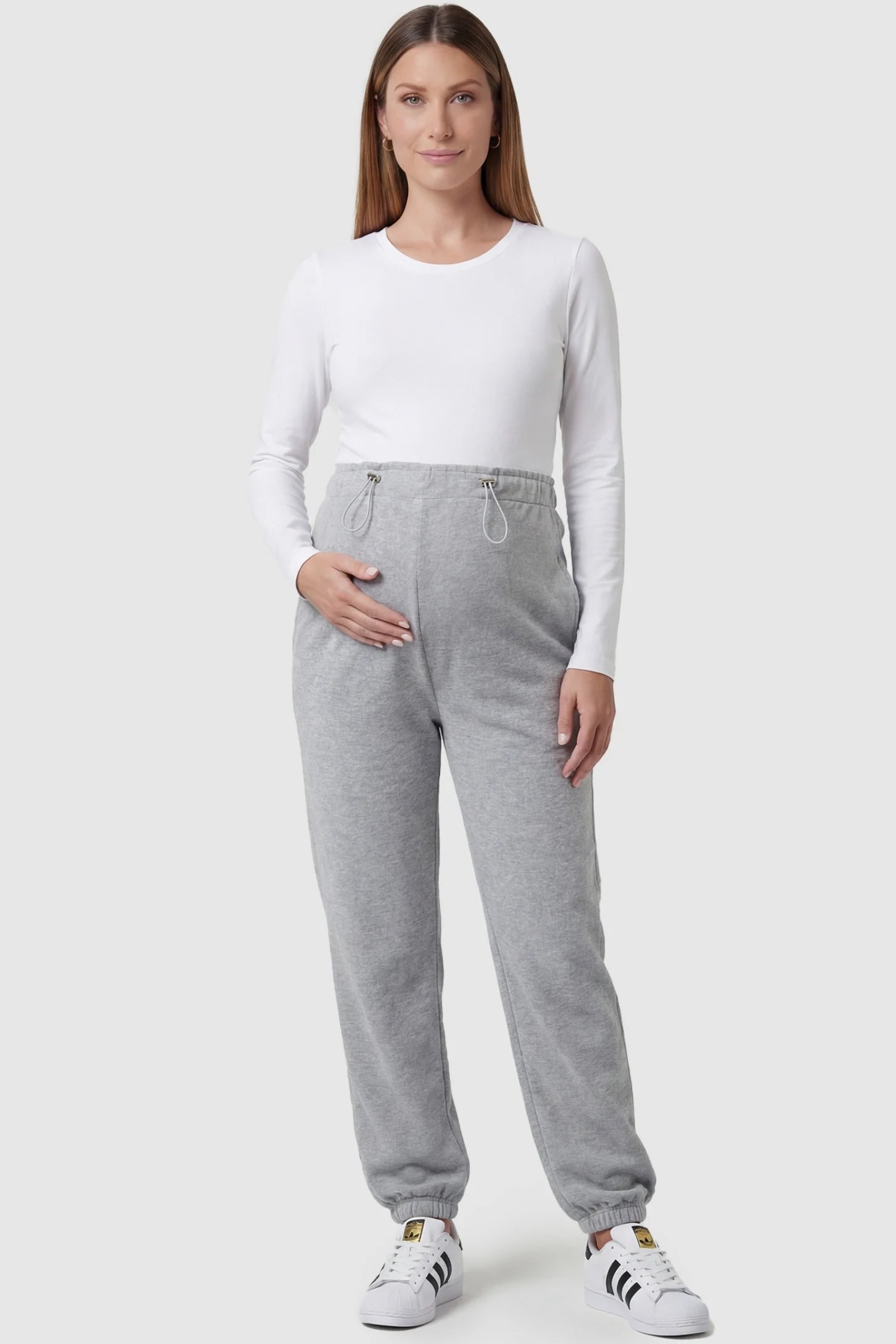 High-Rise Drawstring Waist Loose Fit Jogger Maternity Pants High-rise drawstring waist loose fit jogger maternity pants in gray with relaxed fit, full body on pregnant model