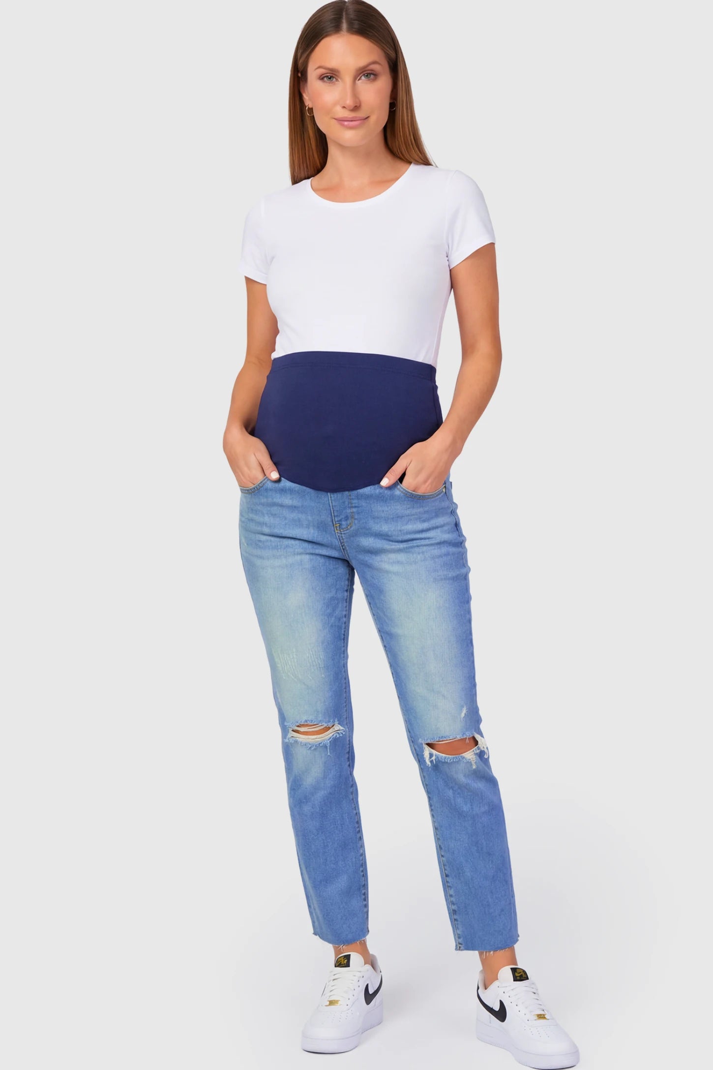 Raw Hem Ankle Straight Leg Maternity Jeans in blue denim featuring high-rise over-the-belly panel and knee-open distressing on pregnant model.