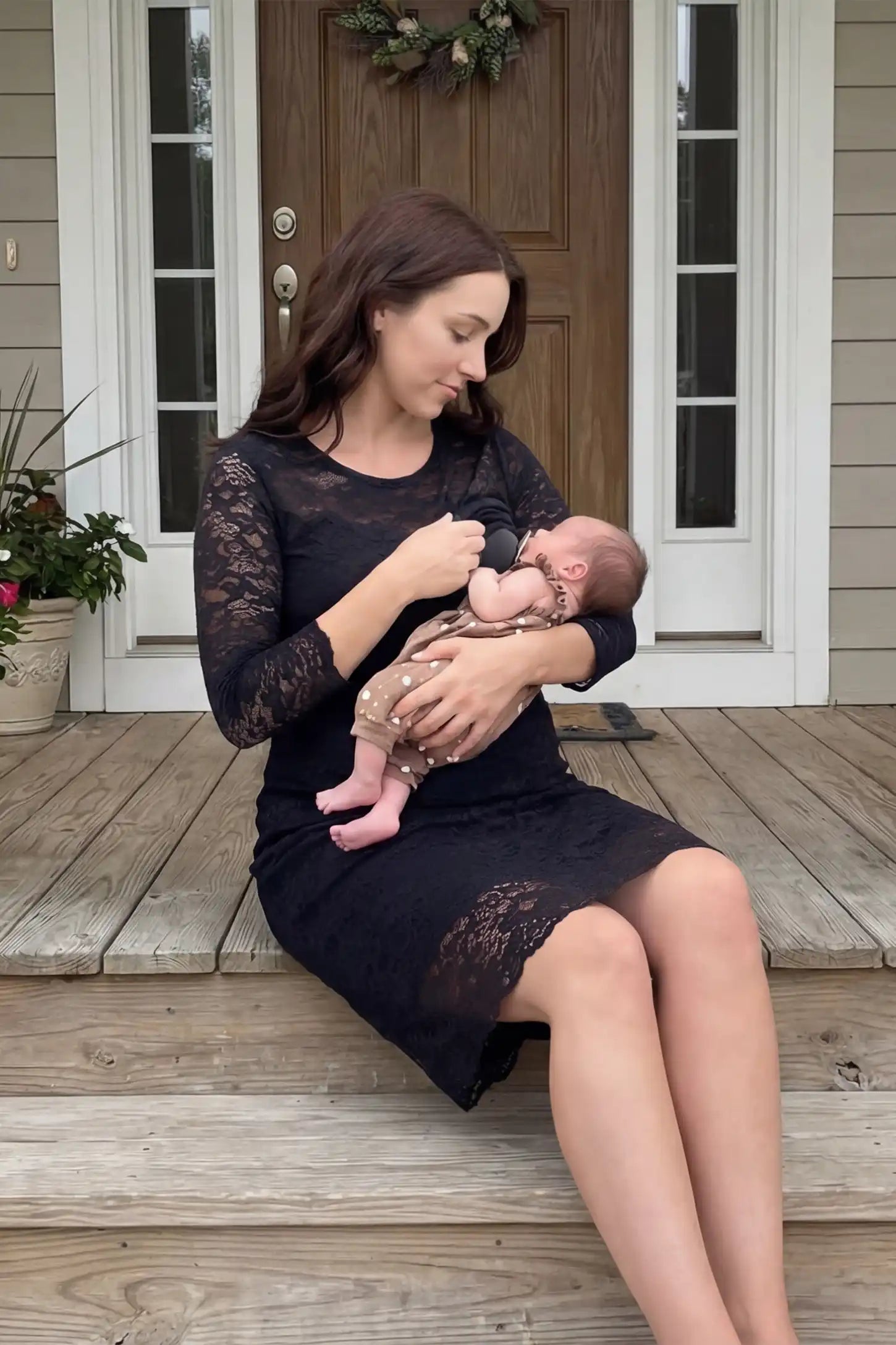 Lace Mid-Length Sleeve Midi Maternity & Nursing Dress Lace mid-length sleeve midi maternity and nursing dress in black featuring concealed nursing opening in front view on a editorial lifestyle model