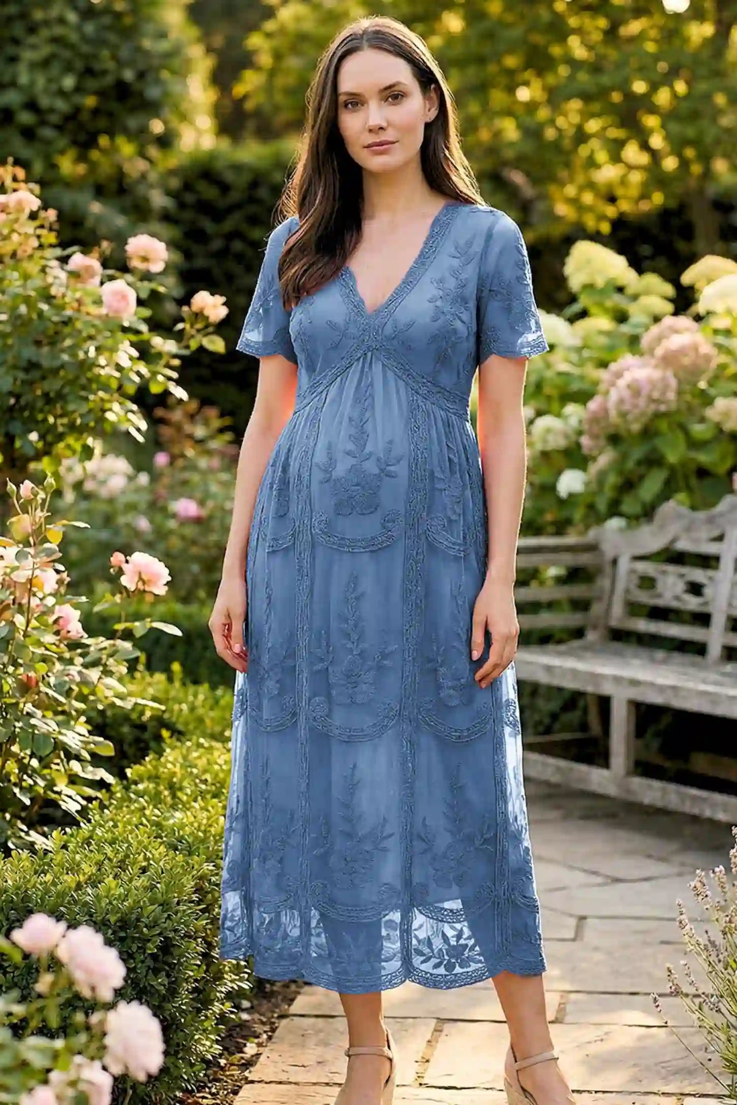 Lace Short Sheer Sleeve Maternity Maxi Dress in blue lace featuring sheer short sleeves and an empire waist silhouette on a pregnant model.