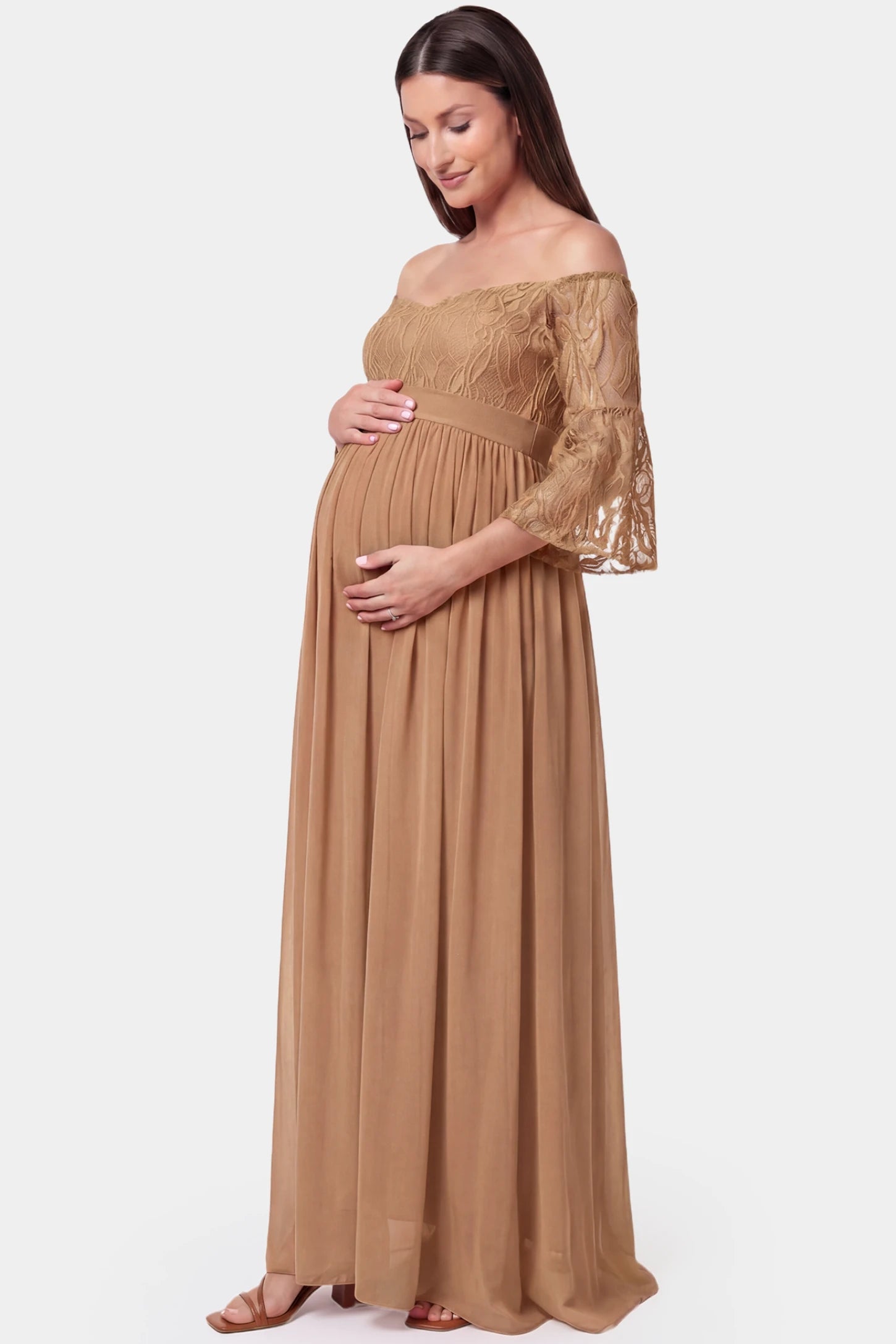 Lace-Spliced Off-Shoulder Flutter Sleeve Maxi Maternity Dress Lace-spliced off-shoulder flutter sleeve maxi maternity dress in coffee featuring high-waisted flowing skirt in side view on a pregnant model