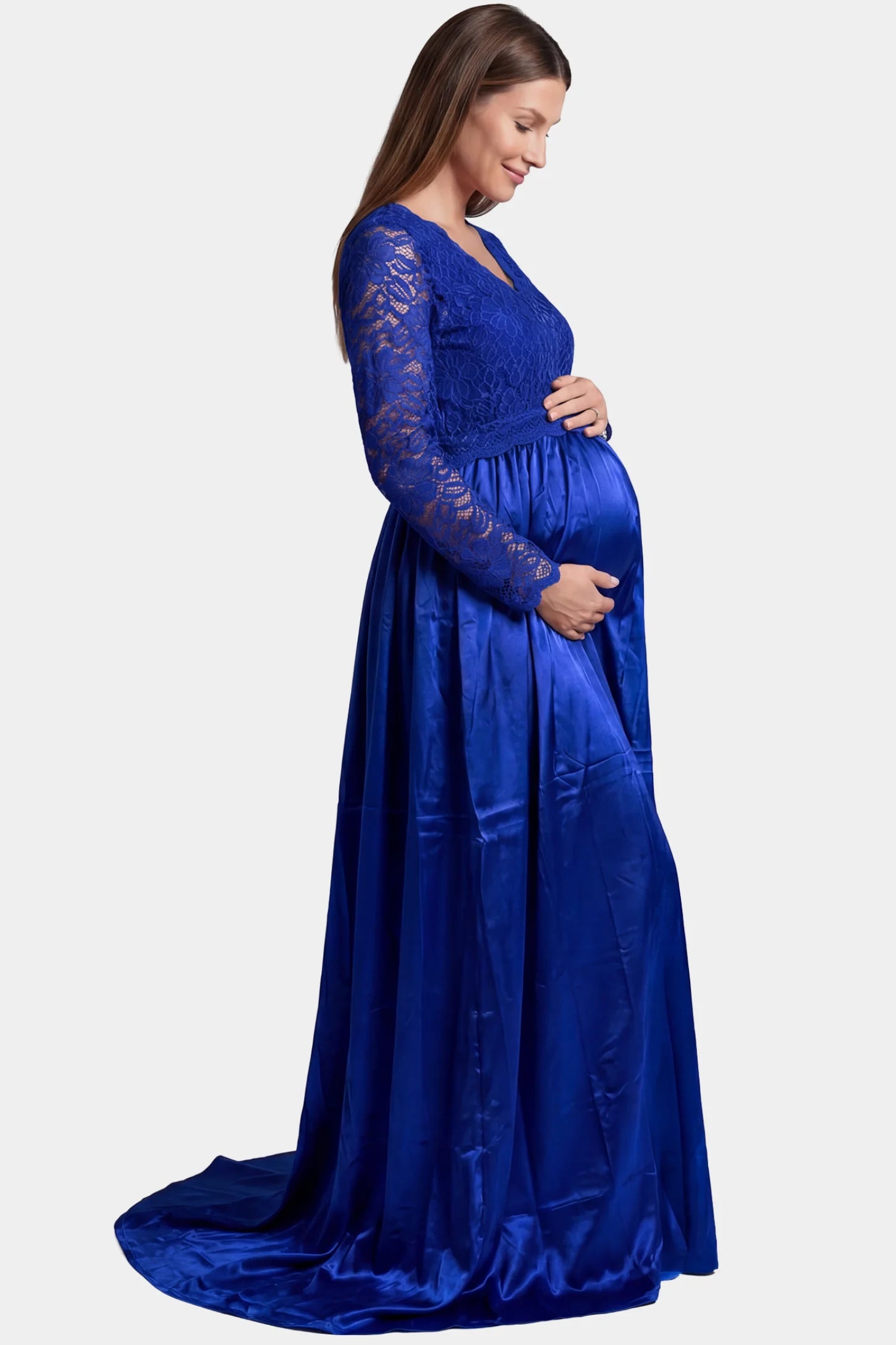 Lace-spliced silk long sleeve maxi maternity dress in blue featuring trailing skirt in full body side view on a pregnant model