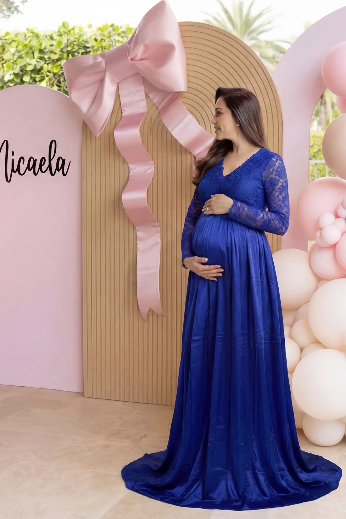 Lace-spliced silk long sleeve maxi maternity dress in blue featuring lace bodice and sleeves in front view on a editorial lifestyle model