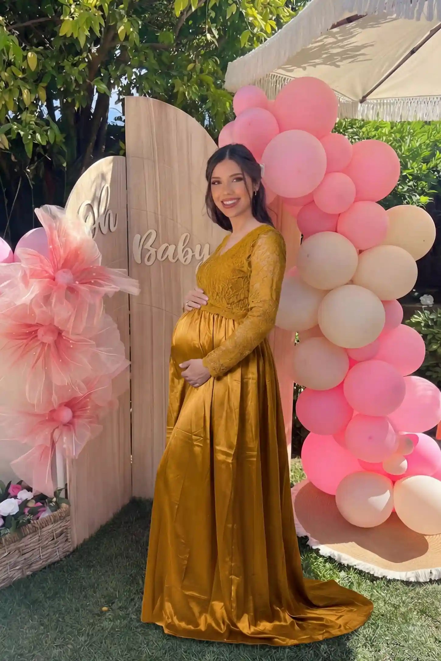 Lace-Spliced Silk Long Sleeve Maxi Maternity Dress Lace-spliced silk long sleeve maxi maternity dress in gold featuring lace bodice and sleeves in front view on a editorial lifestyle model