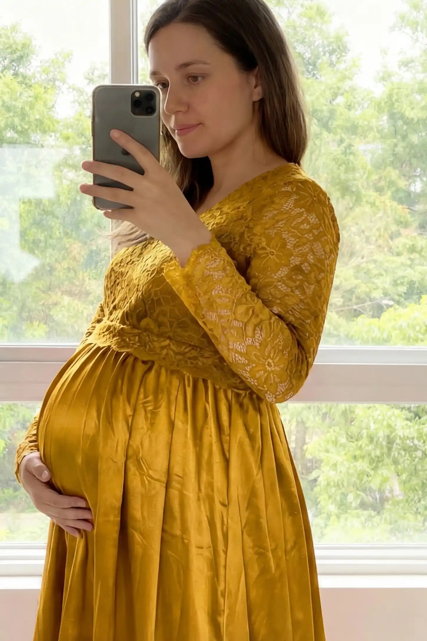 Lace-Spliced Silk Long Sleeve Maxi Maternity Dress Lace-spliced silk long sleeve maxi maternity dress in gold featuring lace bodice and sleeves in front view on a UGC model