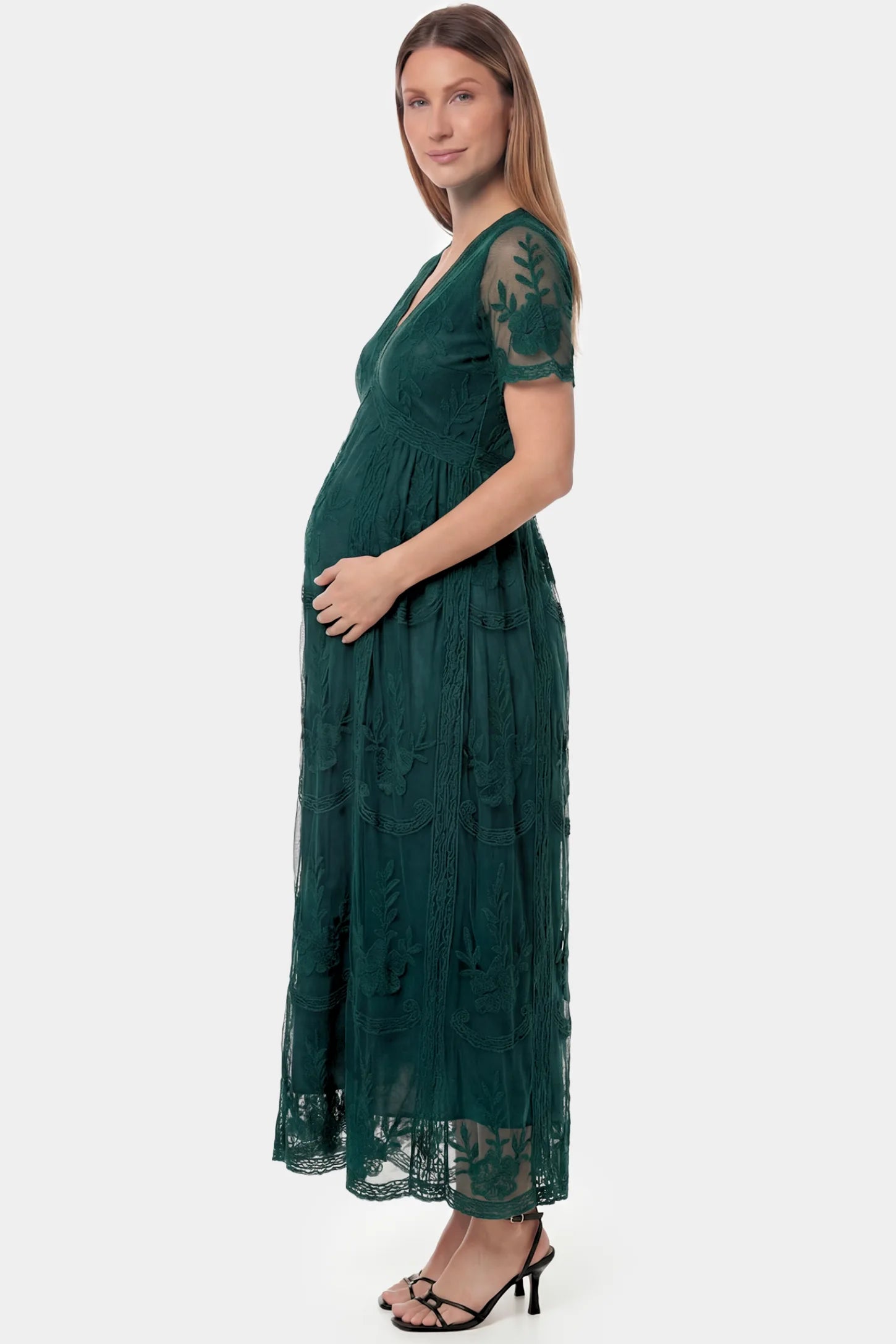 Lace Short Sheer Sleeve Maternity Maxi Dress Lace Short Sheer Sleeve Maternity Maxi Dress in green lace featuring sheer short sleeves and an empire waist silhouette on a pregnant model.