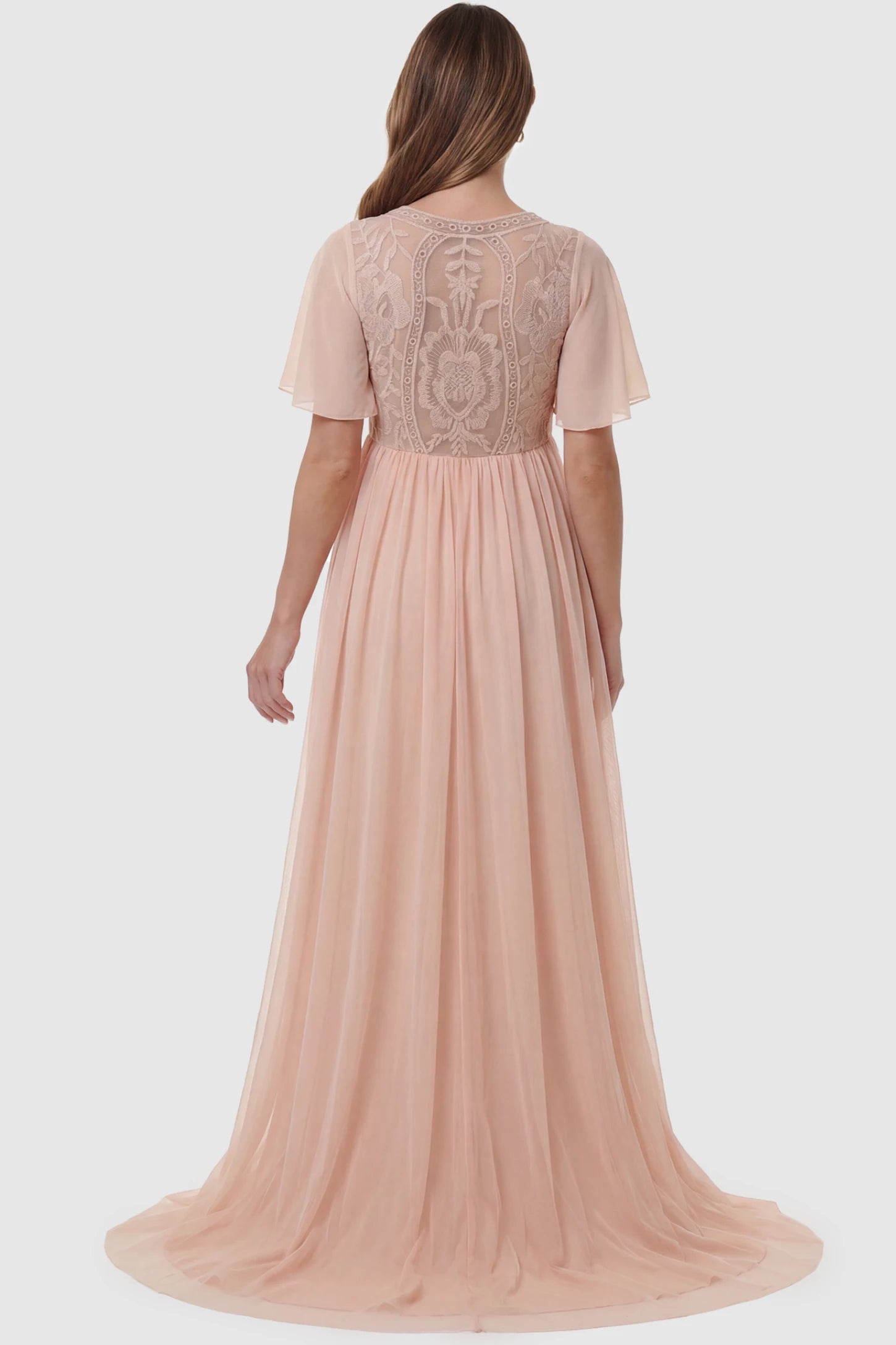 Lace Embroidered Short Flutter Sleeve Maxi Maternity Gown Lace embroidered short flutter sleeve maxi maternity gown in pink featuring short flutter sleeve detail in back view on a pregnant model