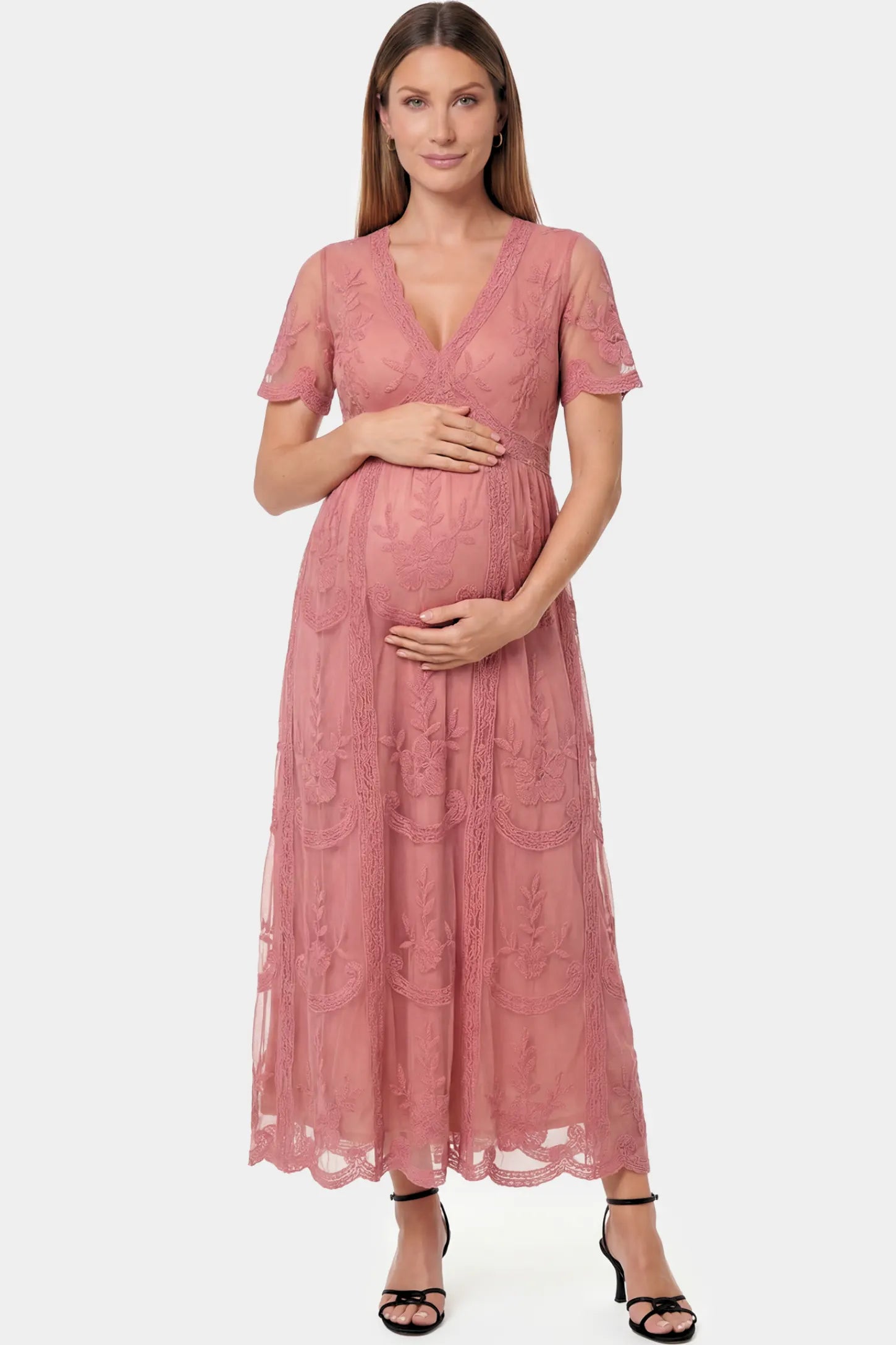 Lace Short Sheer Sleeve Maternity Maxi Dress Lace Short Sheer Sleeve Maternity Maxi Dress in pink lace featuring sheer short sleeves and an empire waist silhouette on a pregnant model.