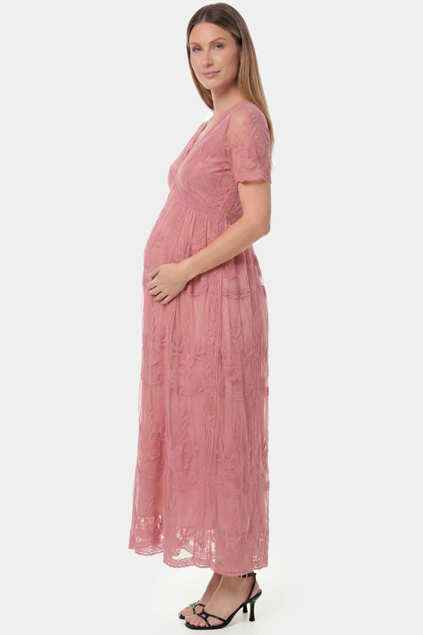 Lace Short Sheer Sleeve Maternity Maxi Dress Lace Short Sheer Sleeve Maternity Maxi Dress in pink lace featuring sheer short sleeves and an empire waist silhouette on a pregnant model.