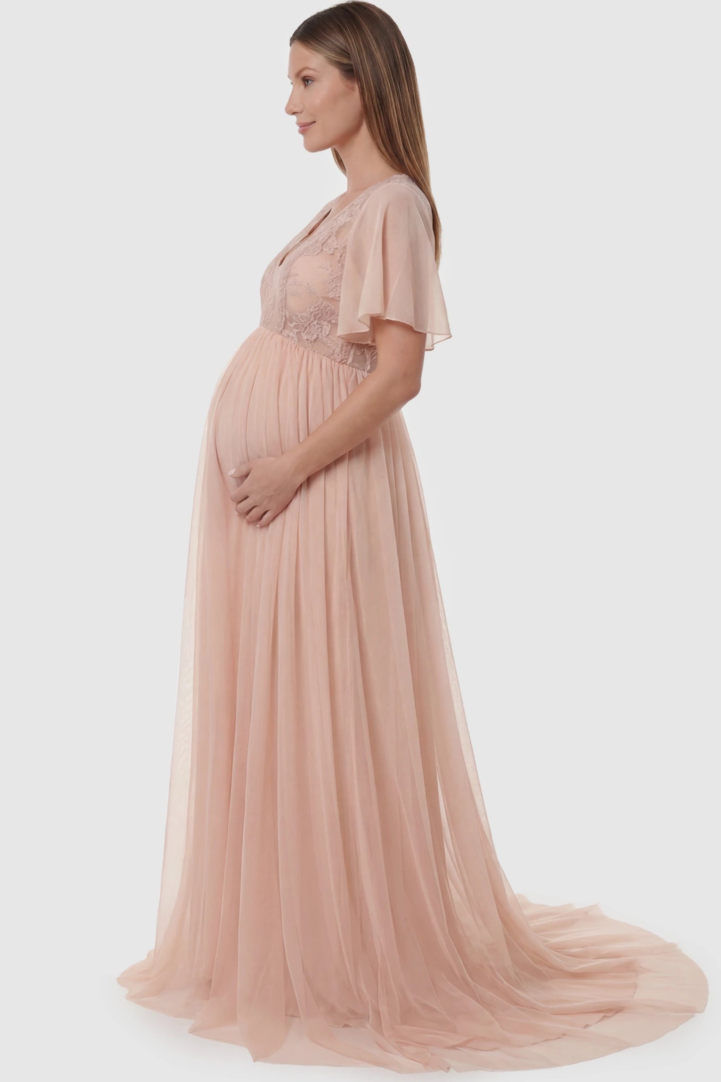 Lace Embroidered Short Flutter Sleeve Maxi Maternity Gown Lace embroidered short flutter sleeve maxi maternity gown in pink featuring graceful long-train design in side view on a pregnant model