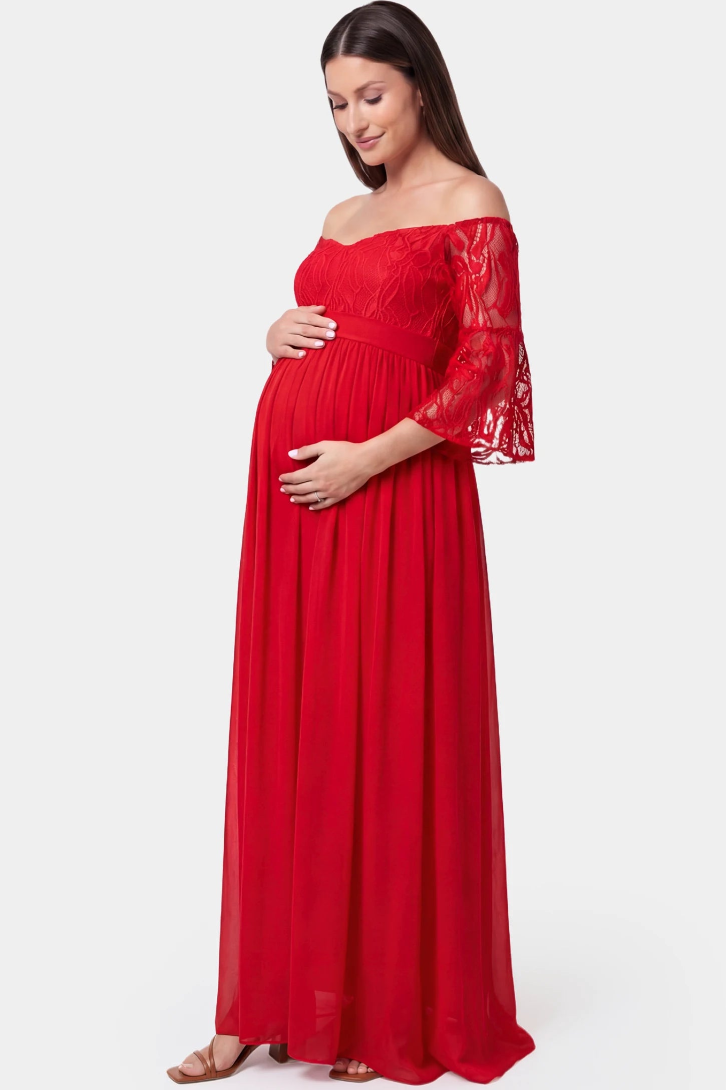 Lace-Spliced Off-Shoulder Flutter Sleeve Maxi Maternity Dress Lace-spliced off-shoulder flutter sleeve maxi maternity dress in red featuring high-waisted flowing skirt in side view on a pregnant model