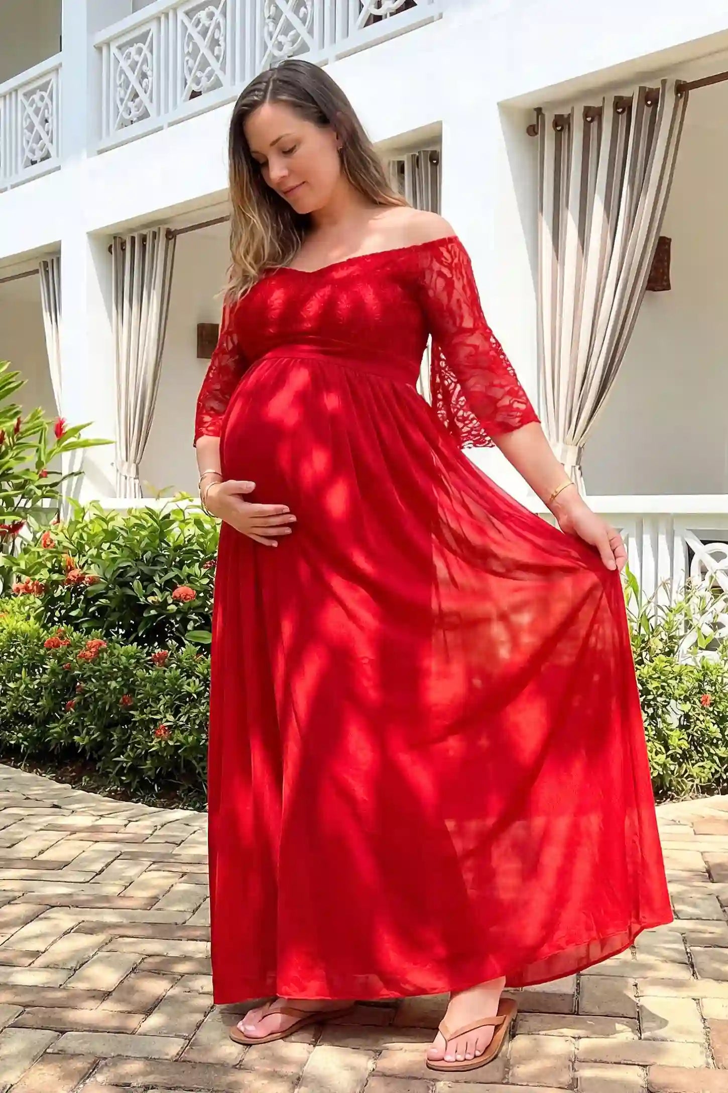 Lace-Spliced Off-Shoulder Flutter Sleeve Maxi Maternity Dress Lace-spliced off-shoulder flutter sleeve maxi maternity dress in red featuring flowing silhouette in full body view on a UGC model