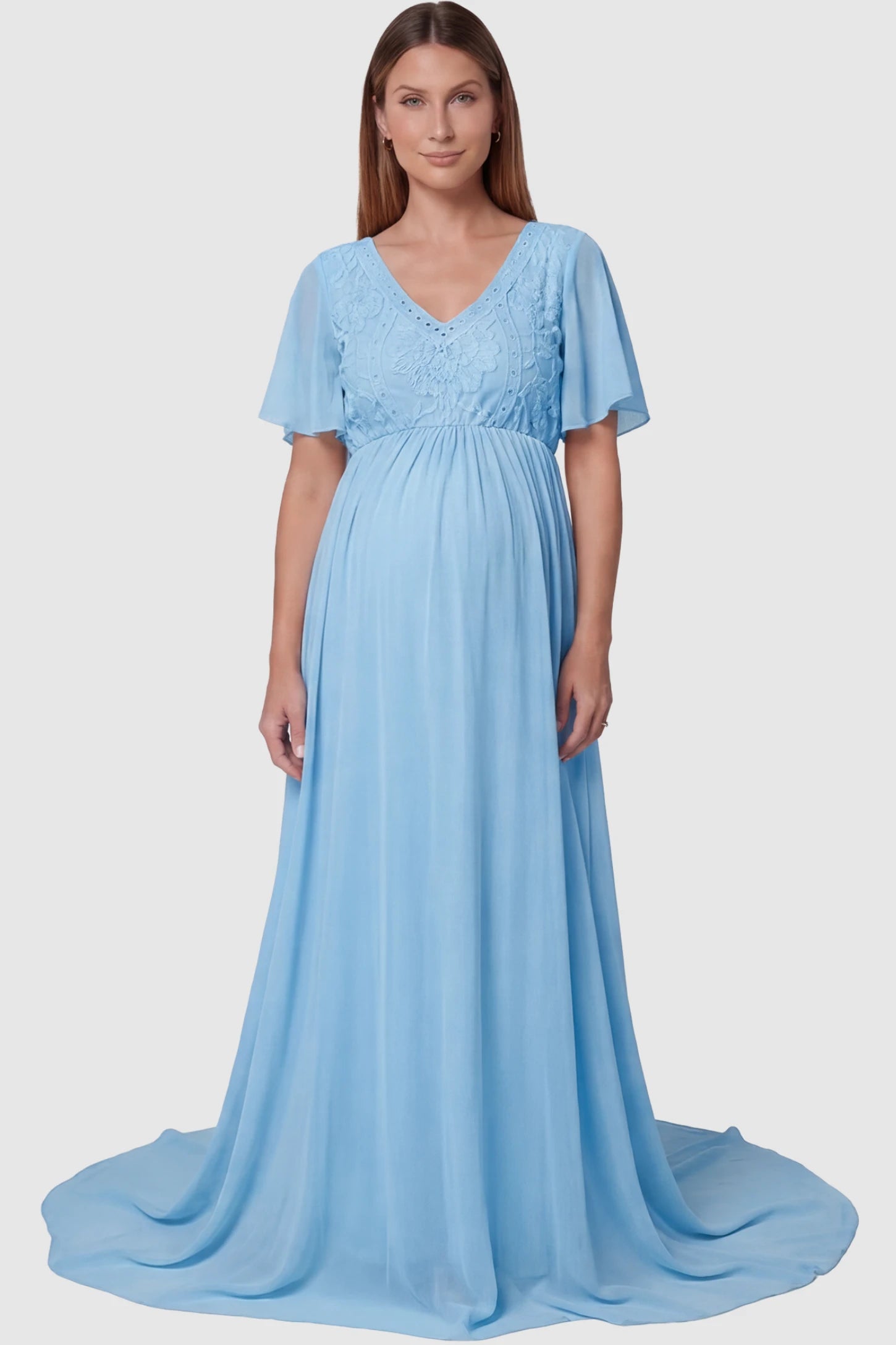 Lace Embroidered Short Flutter Sleeve Maternity Gown Lace embroidered short flutter sleeve maternity gown in sky blue with delicate lace embroidery & flutter sleeves, front view on pregnant model