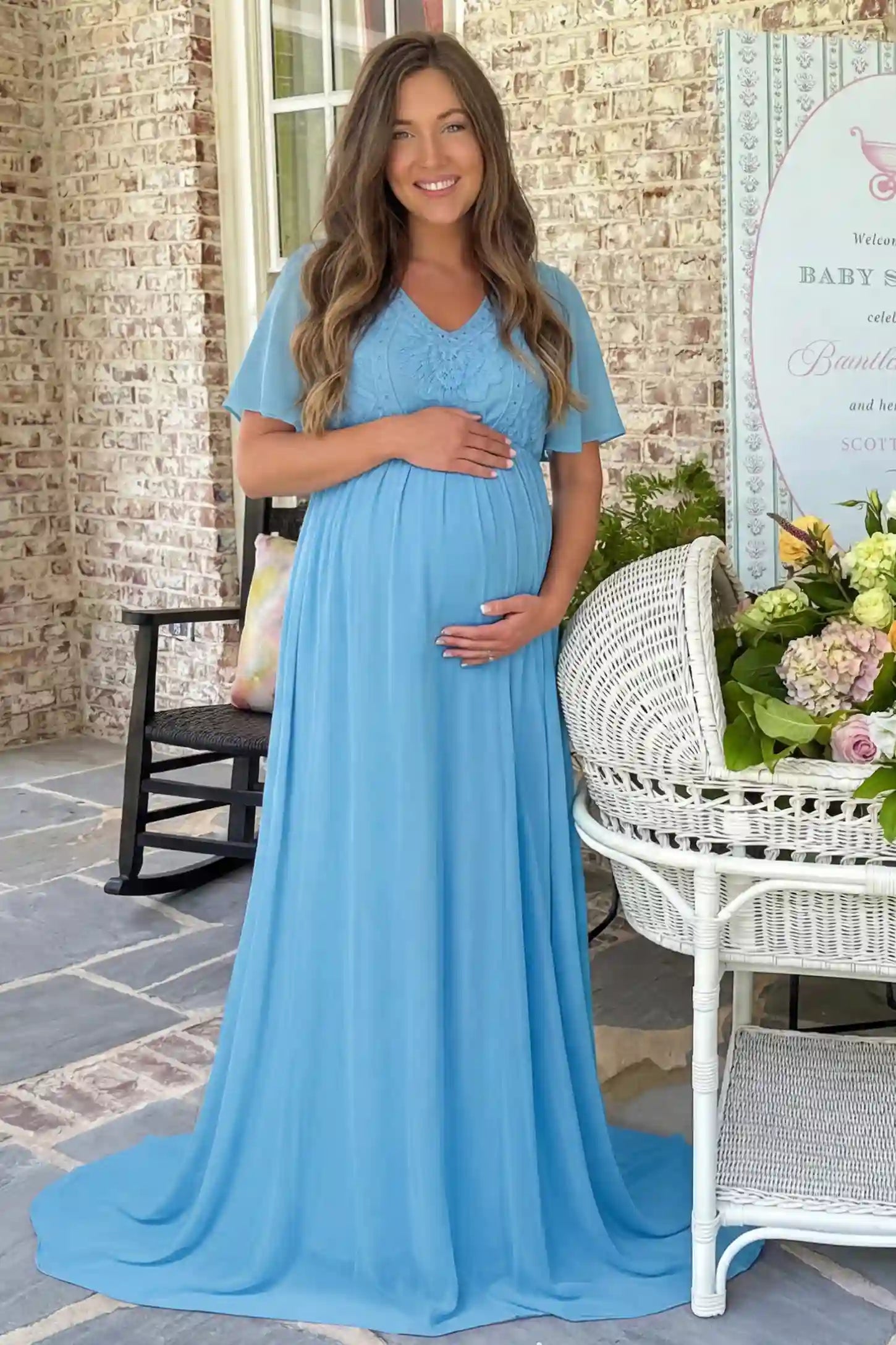 Lace Embroidered Short Flutter Sleeve Maternity Gown Lace embroidered short flutter sleeve maternity gown in sky blue with delicate lace embroidery & flutter sleeves, front view on pregnant model