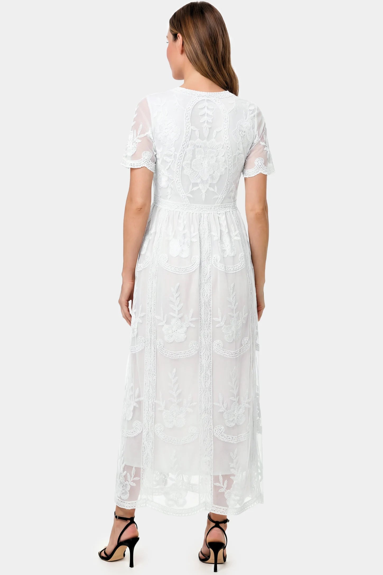 Lace Short Sheer Sleeve Maternity Maxi Dress Lace Short Sheer Sleeve Maternity Maxi Dress in white lace featuring sheer short sleeves and an empire waist silhouette on a pregnant model.