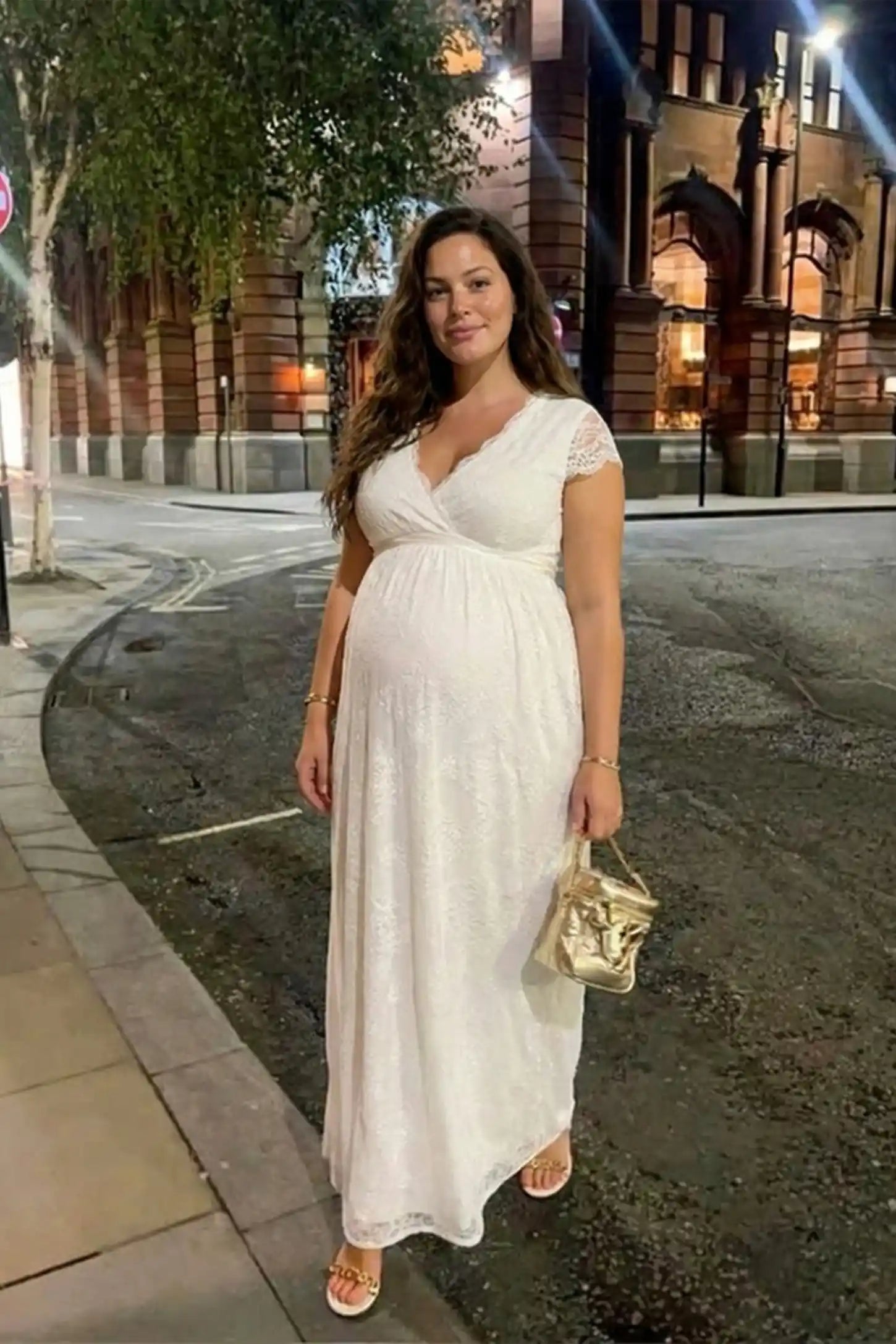 Lace flutter sleeve V-neck maxi maternity dress in white with elegant lace craftsmanship, on editorial lifestyle model