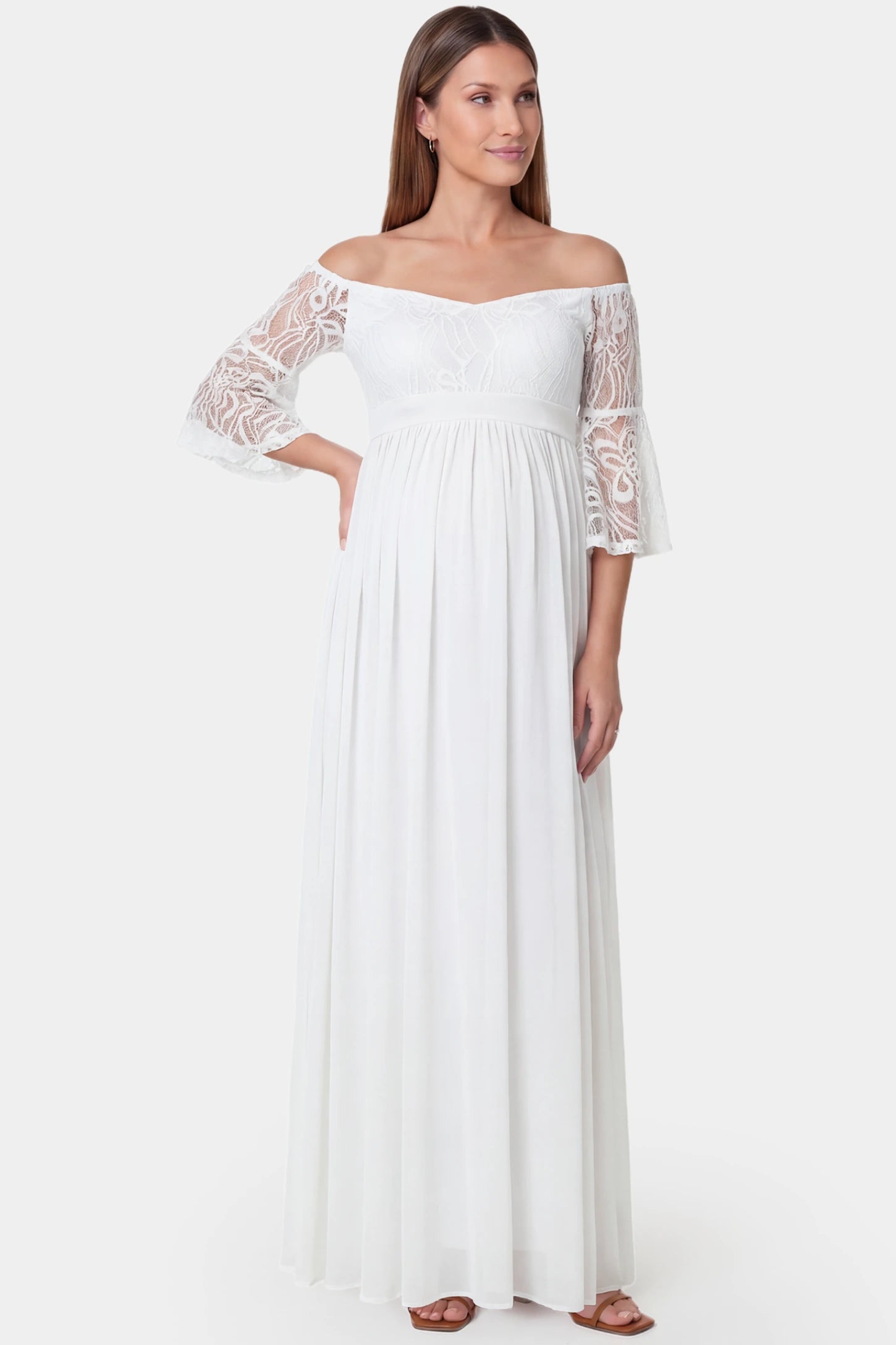 Lace-spliced off-shoulder flutter sleeve maxi maternity dress in white featuring romantic lace detailing and off-shoulder in front view on a pregnant model