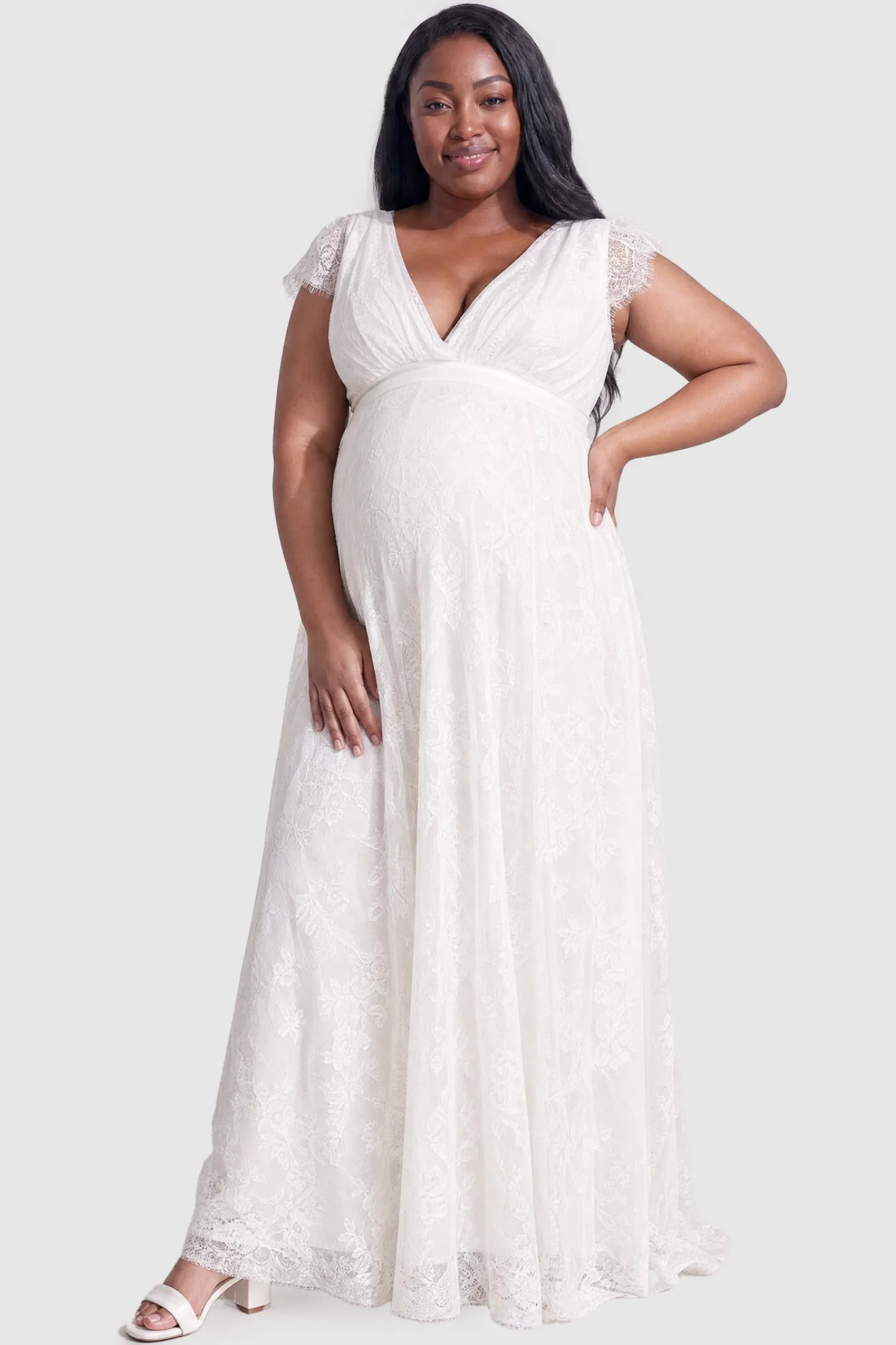 Lace Flutter Sleeve Maxi Maternity Dress Lace flutter sleeve V-neck maxi maternity dress in white featuring V-neckline and lace splicing in front view on a plus-size model