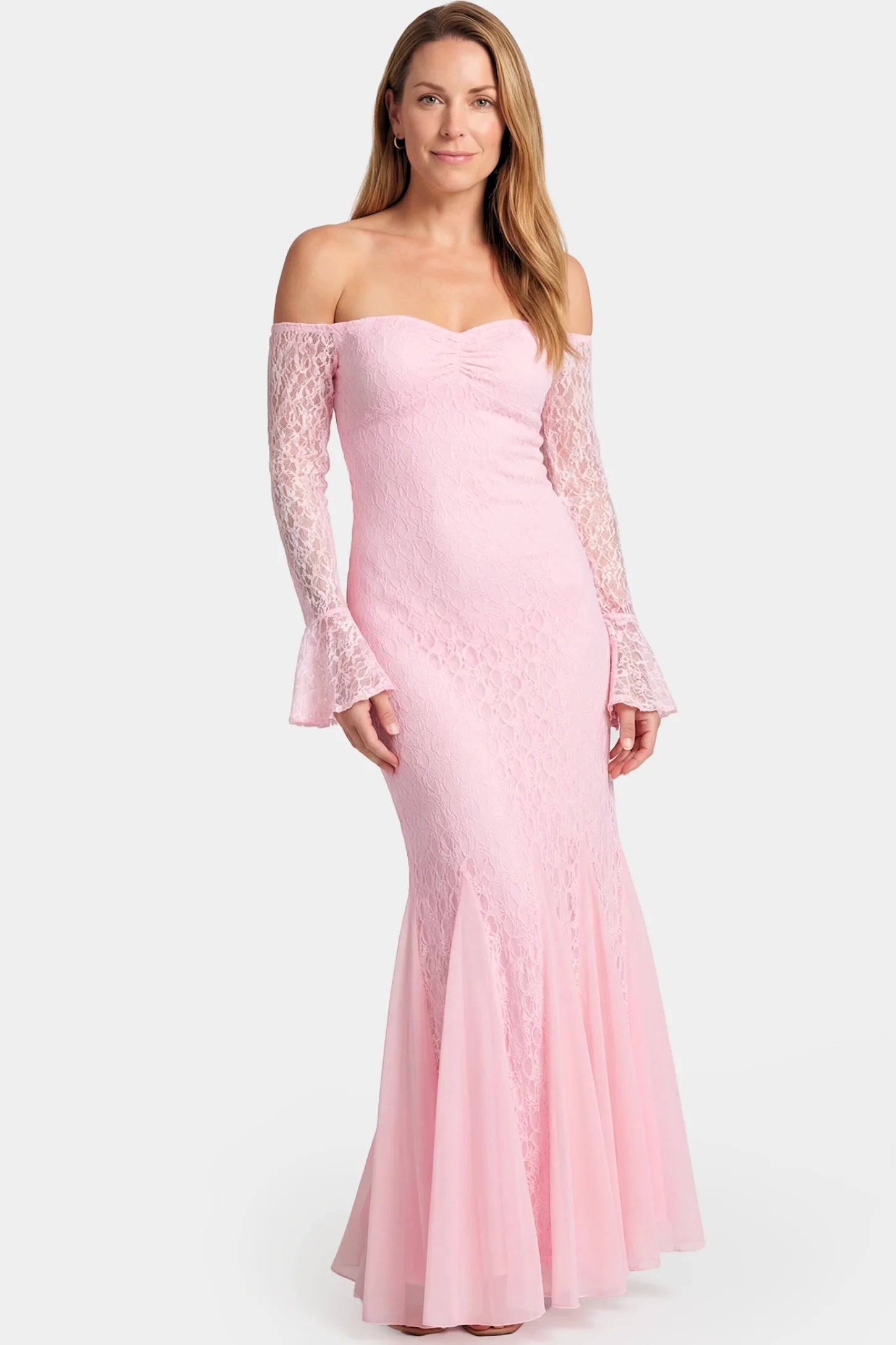 Lace Off Shoulder Mermaid Maternity Gown Lace Off Shoulder Mermaid Maternity Gown in pink lace featuring a sweetheart neckline, long sleeves, and a fitted mermaid silhouette on a non pregnant model.