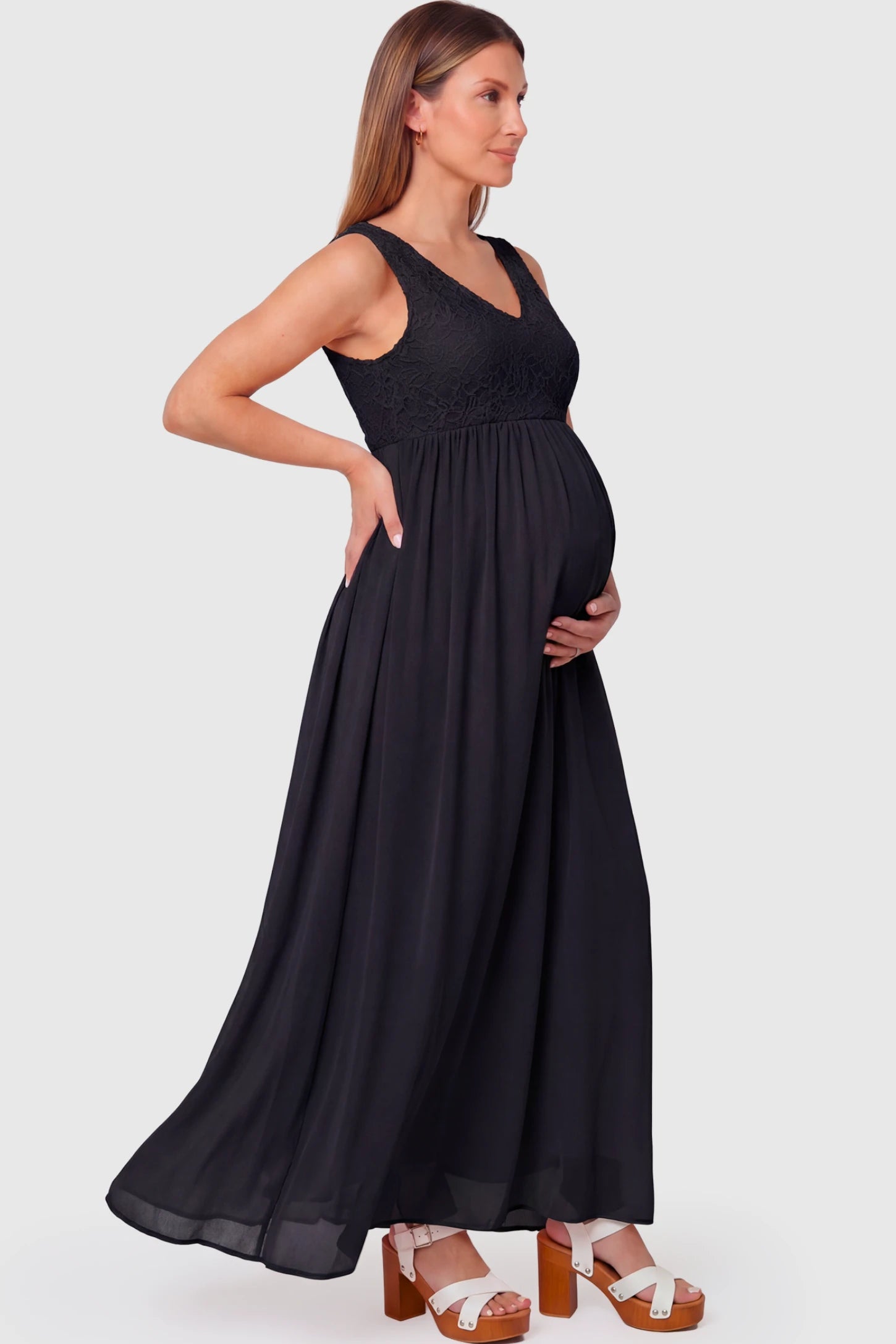 Lace Empire Waist Maternity Maxi Dress Lace Empire Waist Maternity Maxi Dress in black featuring V-neckline and flowing relaxed fit on pregnant model.